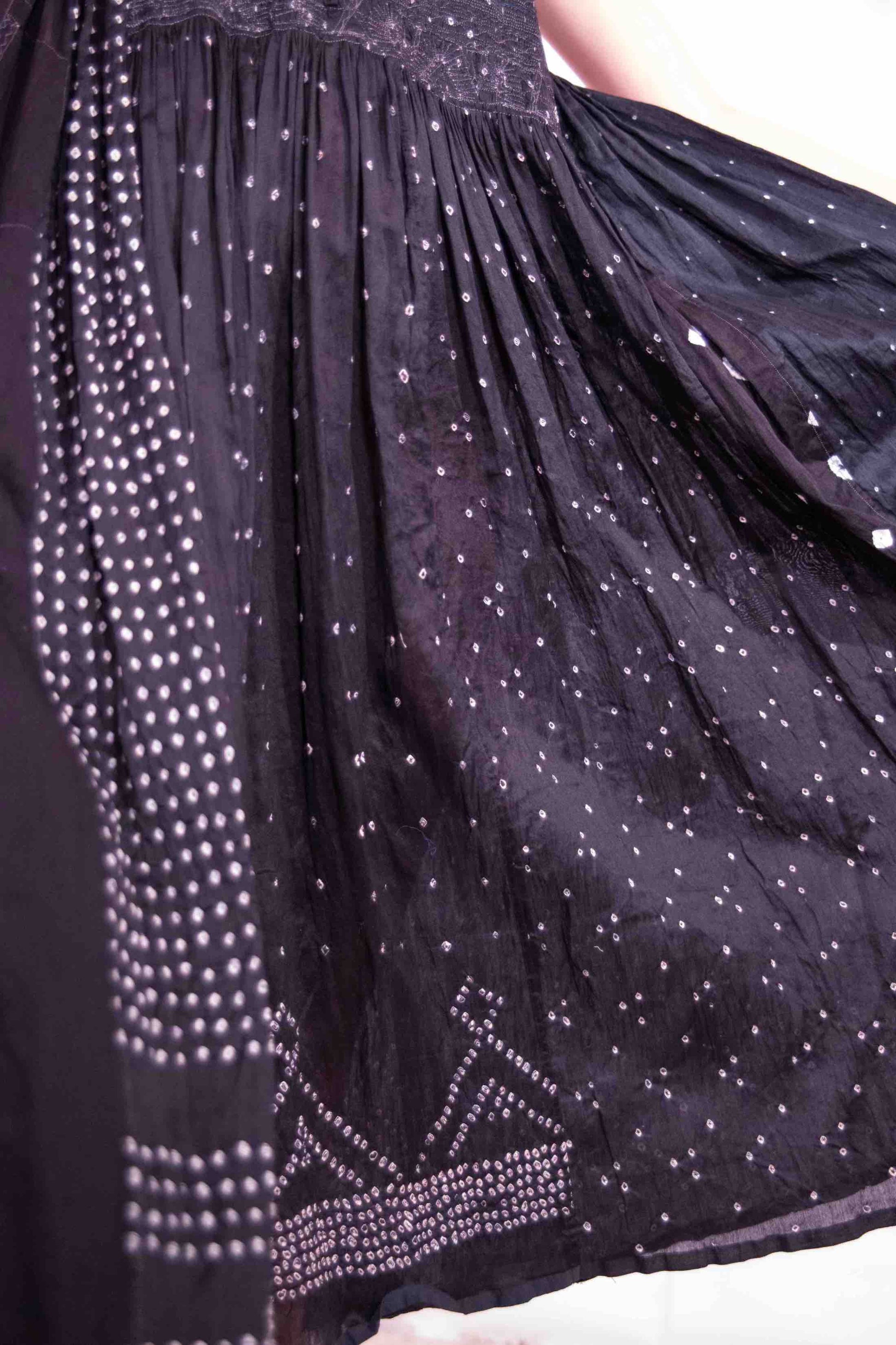 Model is wearing a long, flowing silk-cotton blend dress in black with navy and white accents. Features a softly flared skirt. Handmade in India with traditional techniques by Injiri.