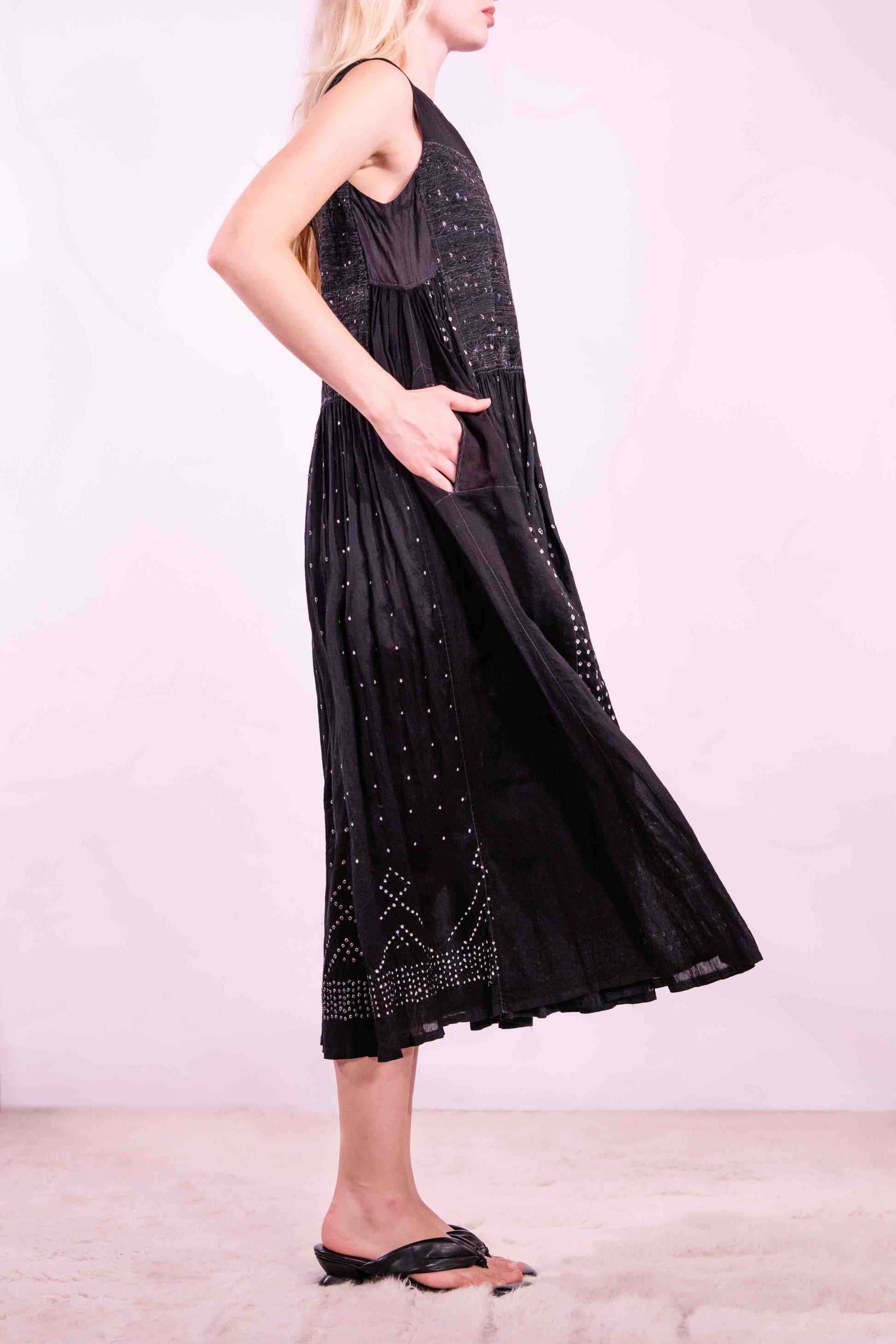 Model is wearing a long, flowing silk-cotton blend dress in black with navy and white accents. Features a softly flared skirt. Handmade in India with traditional techniques by Injiri.