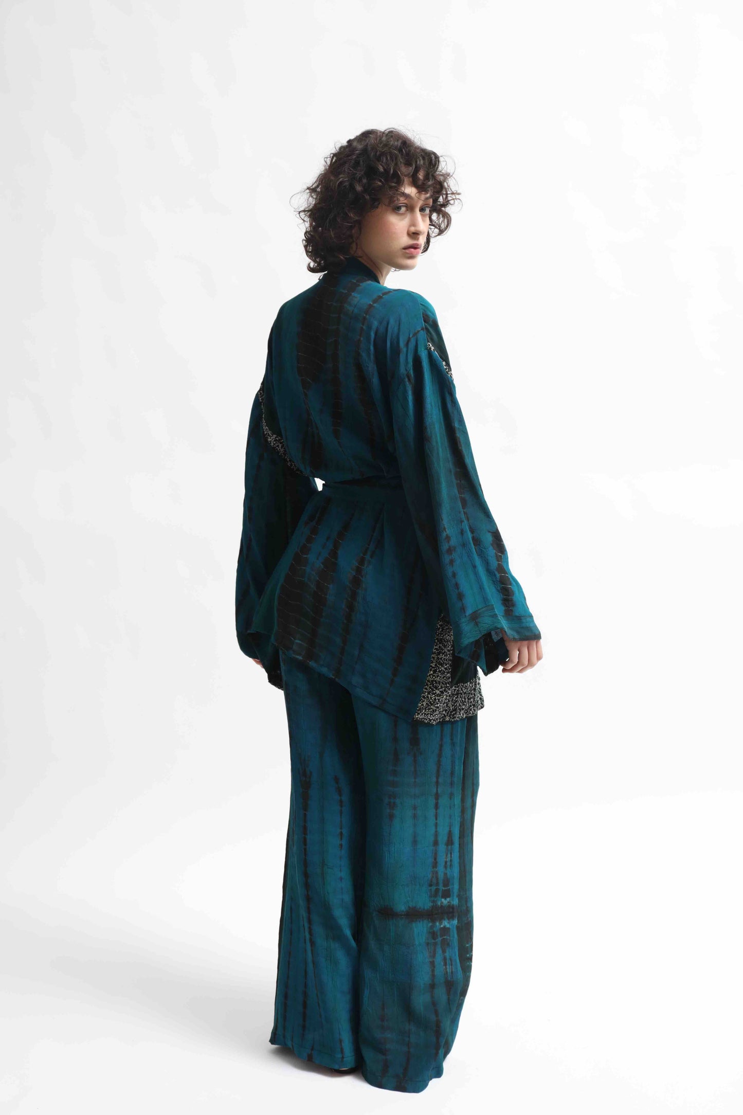 One-of-a-kind kimono suit made from upcycled antique saris, hand-dyed in India with the Shibori technique. Limited-edition, sustainable luxury by House of Woven Stories. Available in multiple colors.