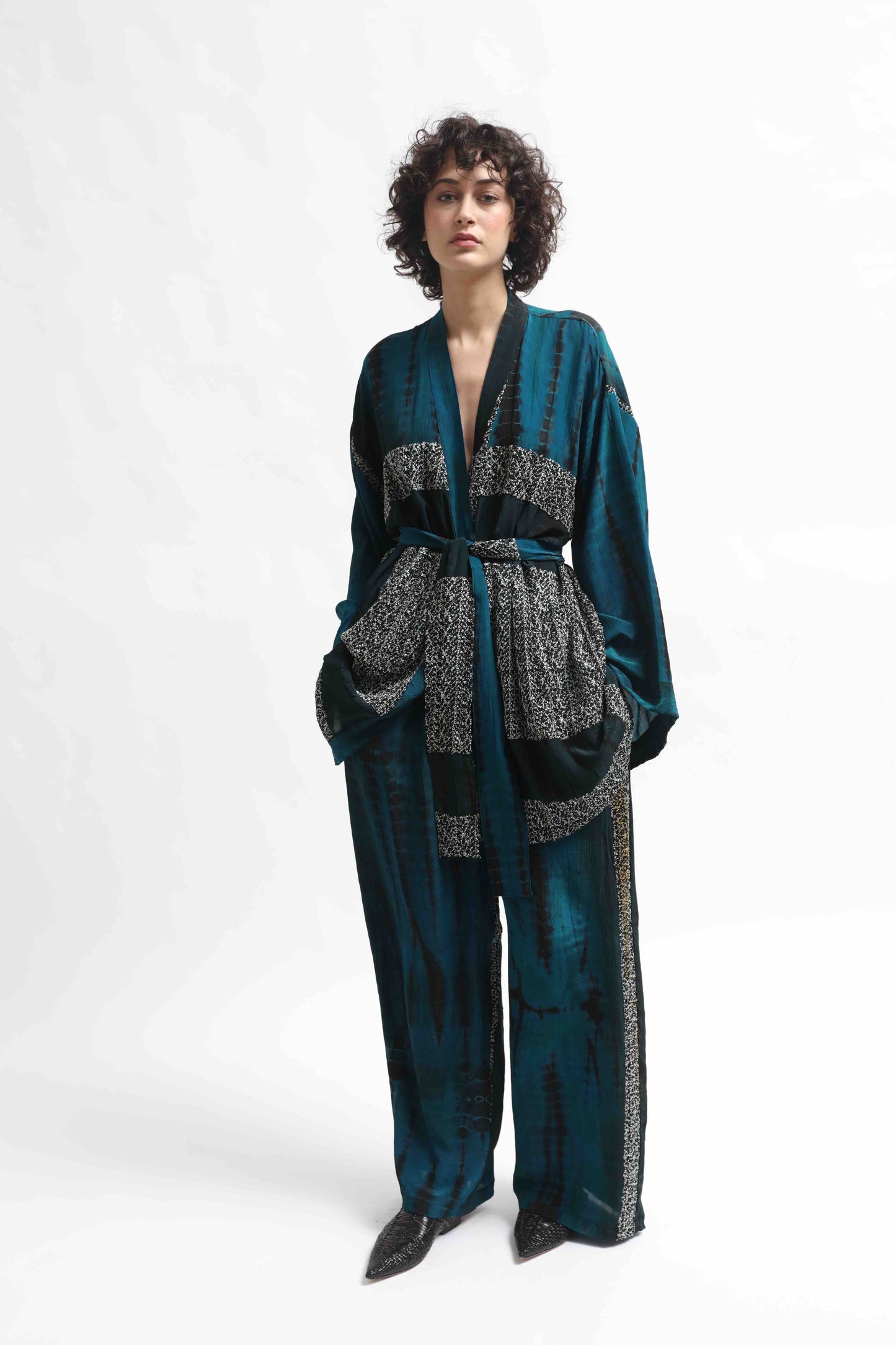 One-of-a-kind kimono suit made from upcycled antique saris, hand-dyed in India with the Shibori technique. Limited-edition, sustainable luxury by House of Woven Stories. Available in multiple colors.