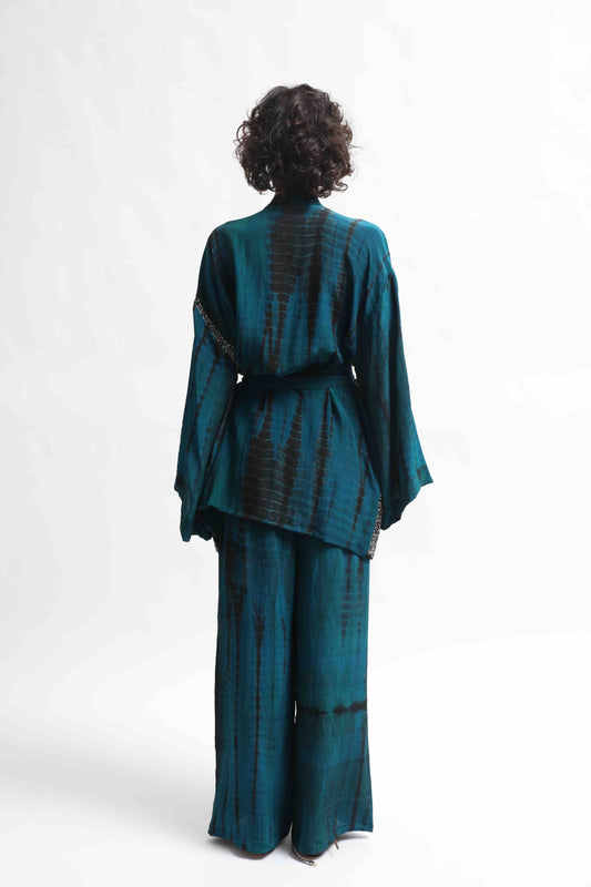 One-of-a-kind kimono suit made from upcycled antique saris, hand-dyed in India with the Shibori technique. Limited-edition, sustainable luxury by House of Woven Stories. Available in multiple colors.