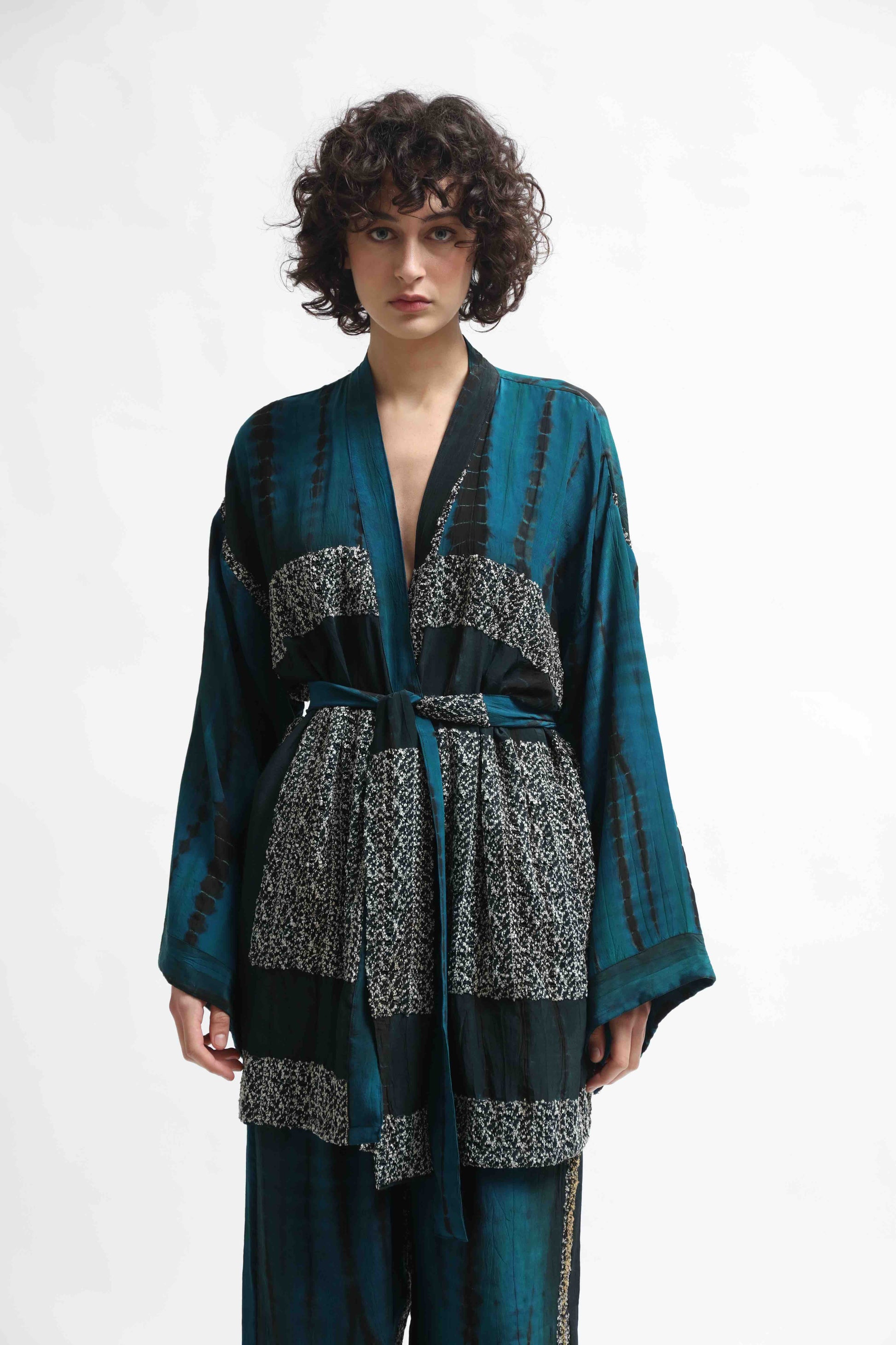 One-of-a-kind kimono suit made from upcycled antique saris, hand-dyed in India with the Shibori technique. Limited-edition, sustainable luxury by House of Woven Stories. Available in multiple colors.