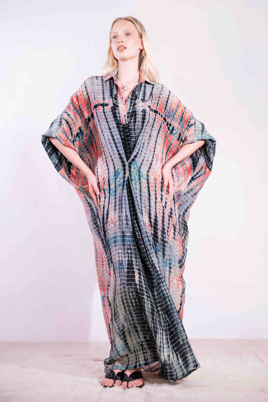Model wearing the Barcelona Breeze Dress - a handcrafted silk dress with batwing sleeves, V-neck, and Shibori-dyed pattern, made in Italy by House of Woven Stories.