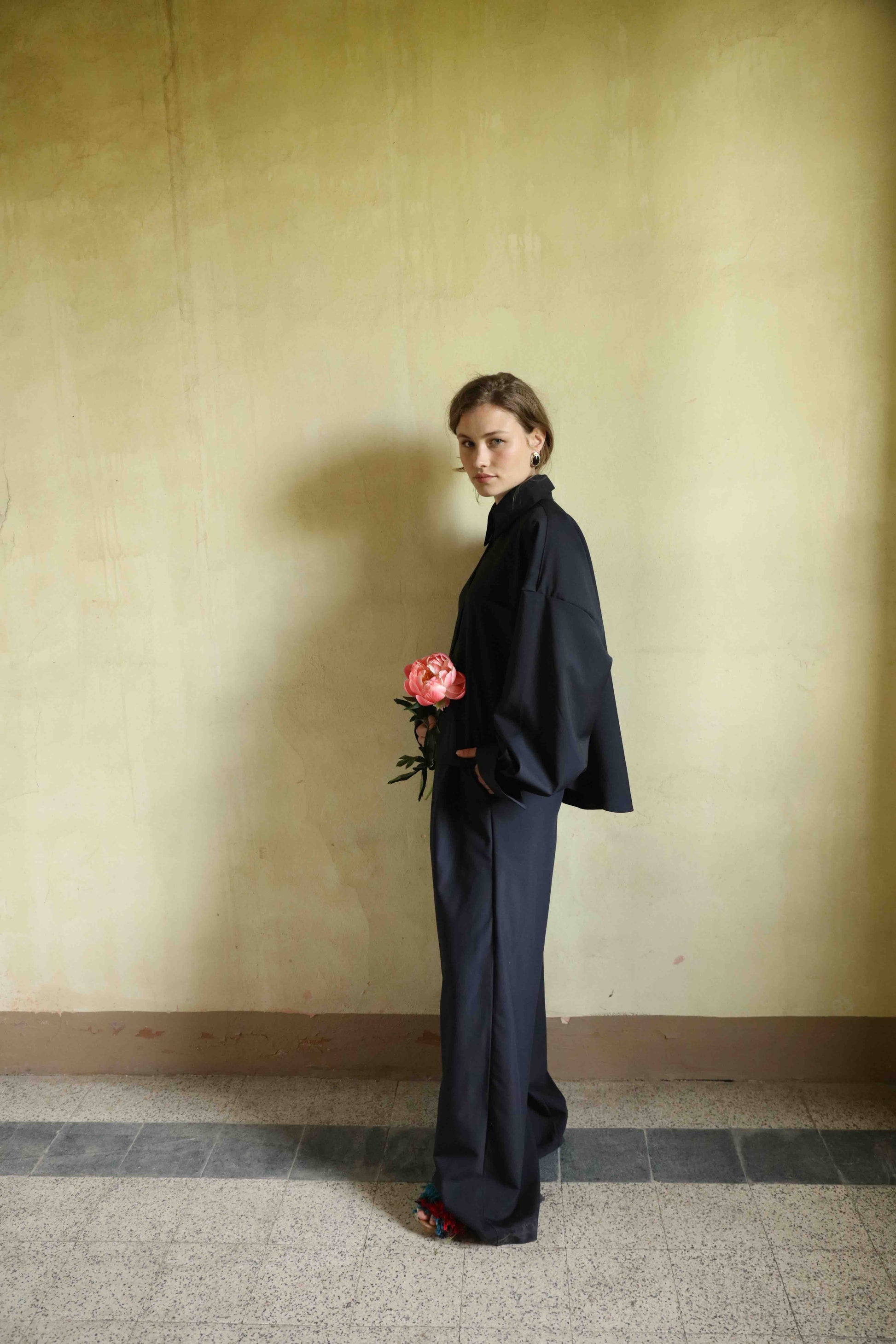 A timeless blouse crafted from 100% cool wool by skilled artisans in Italy for House of Woven Stories. Lightweight and breathable, it features refined details for effortless elegance throughout the year.
