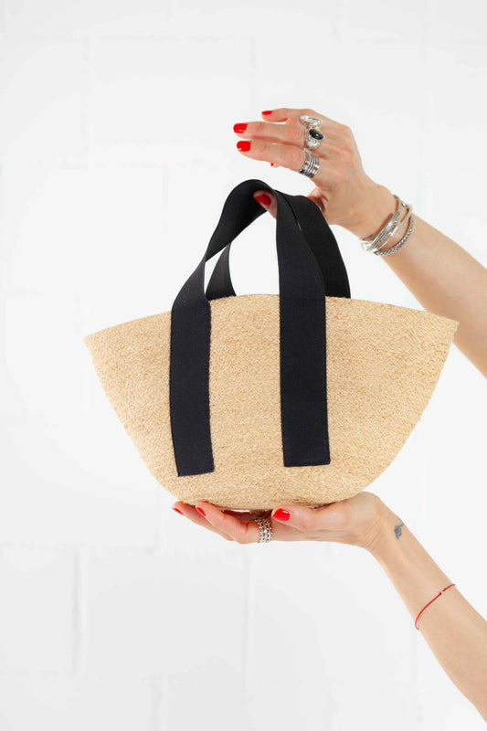Black Mini Market raffia bag by Lola Hats with elastic handles and stitched raffia tape design. Available at House of Woven Stories.