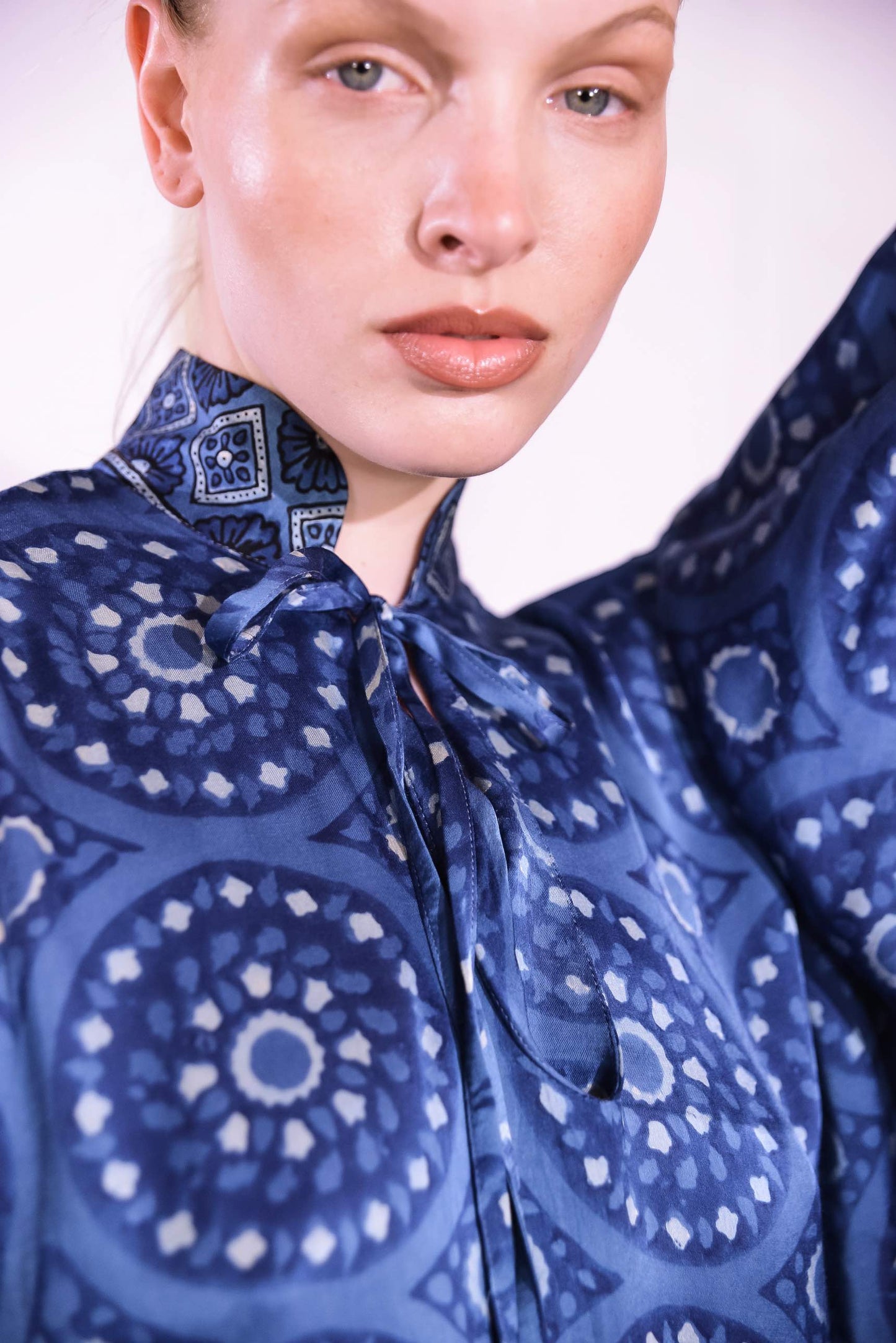 Model wearing Blue Circles Marion Silk Dress by Obidi. Handprinted silk maxi dress with V-neckline, natural indigo Ajrakh blockprint, side pockets, and fluid silhouette. Ethically made in India using traditional techniques.