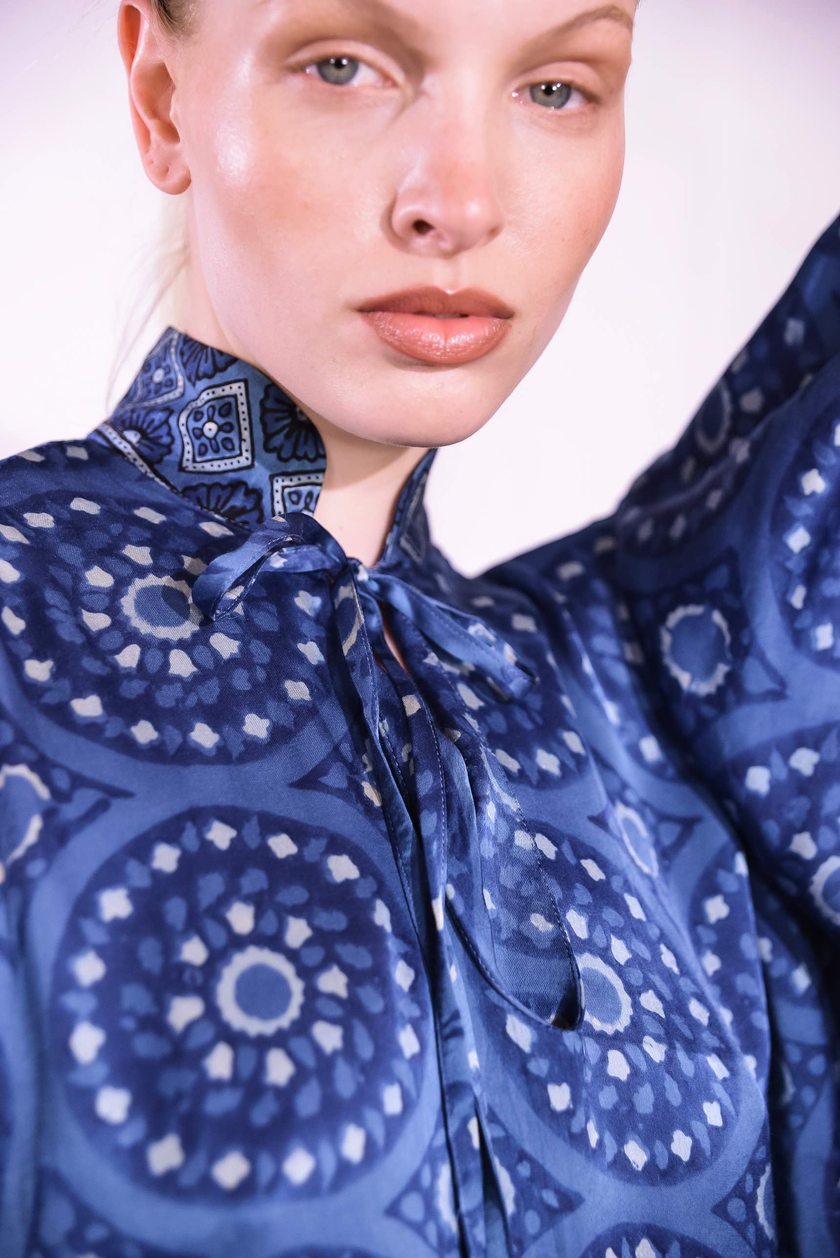 Model wearing Blue Circles Marion Silk Dress by Obidi. Handprinted silk maxi dress with V-neckline, natural indigo Ajrakh blockprint, side pockets, and fluid silhouette. Ethically made in India using traditional techniques.