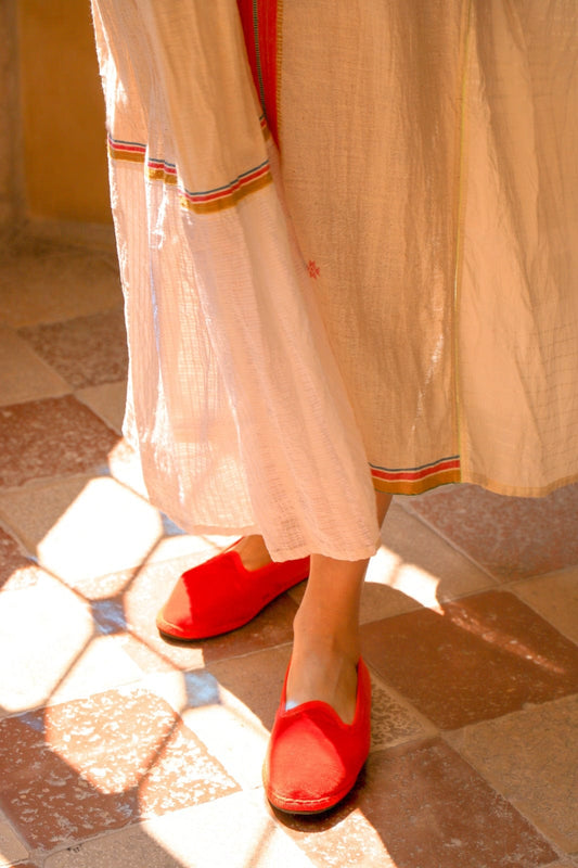 Handmade in Venice from upcycled luxury fabrics with recycled rubber soles. Bright Orange Venetian Slippers by Teod’amar are timeless and sustainable. Part of House of Woven Stories section. 