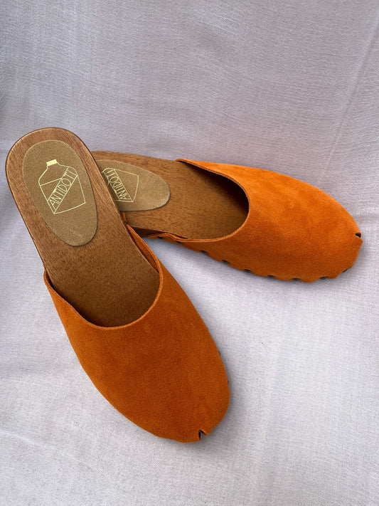Handmade tangerine velvet clogs by Antidoti with studded sides and wooden sole, crafted in Florence, Italy. Available at House of Woven Stories.