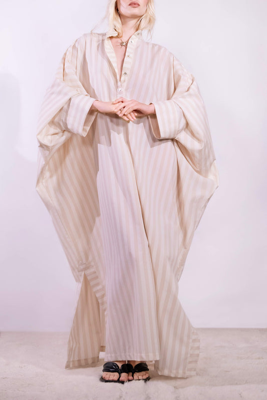 Model wearing the Fez striped shirt dress with batwing sleeves and button placket, handcrafted in Italy from 100% cotton by House of Woven Stories.
