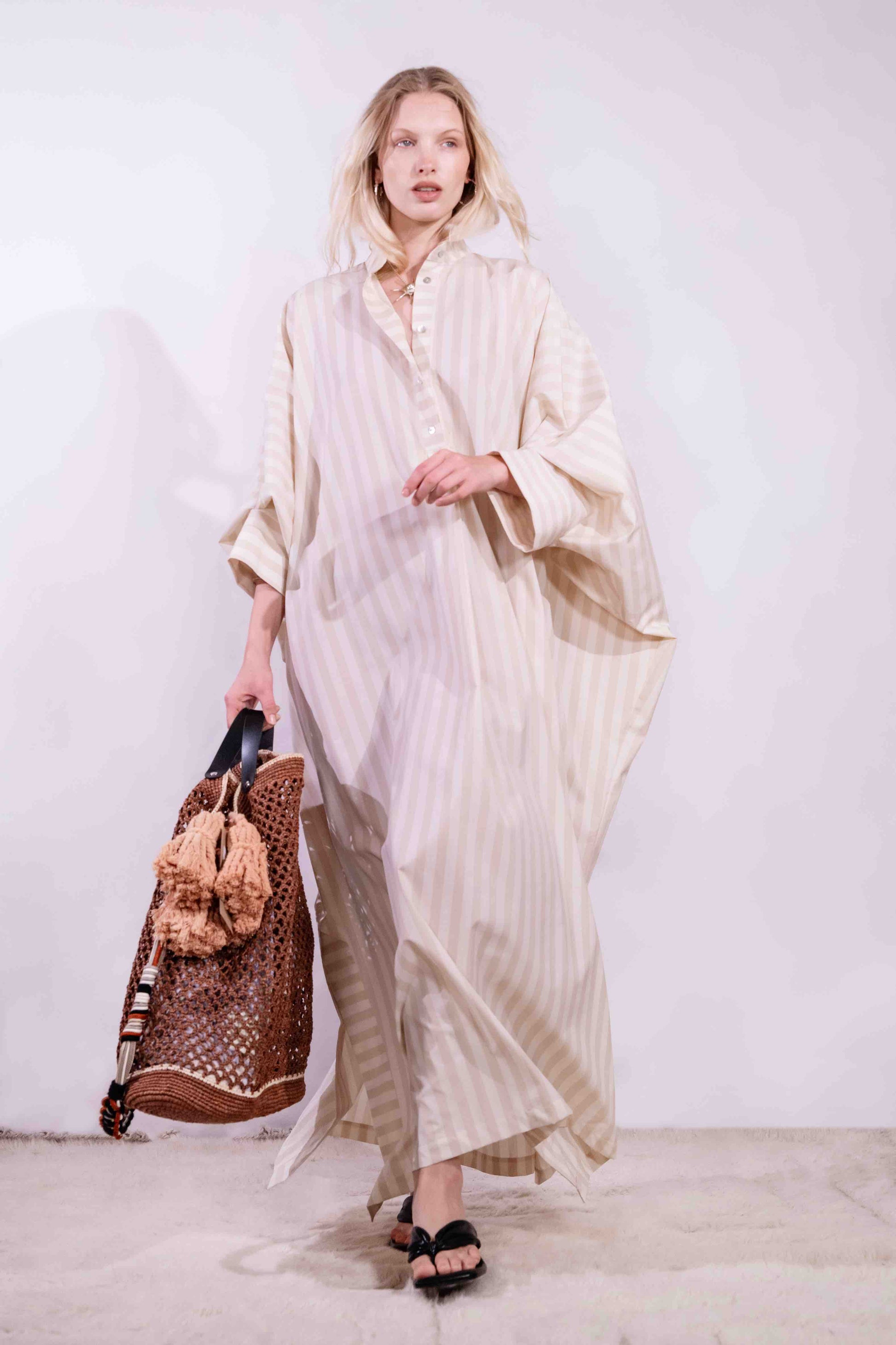Model wearing the Fez striped shirt dress with batwing sleeves and button placket, handcrafted in Italy from 100% cotton by House of Woven Stories.