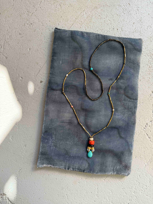 Striking handcrafted choker necklace with pyrite, pink bamboo coral, turquoise, bone inlay, and brass details. Made in Italy by Ilaria Fiorentini Jewellery. Part of the House of Woven Stories selection.