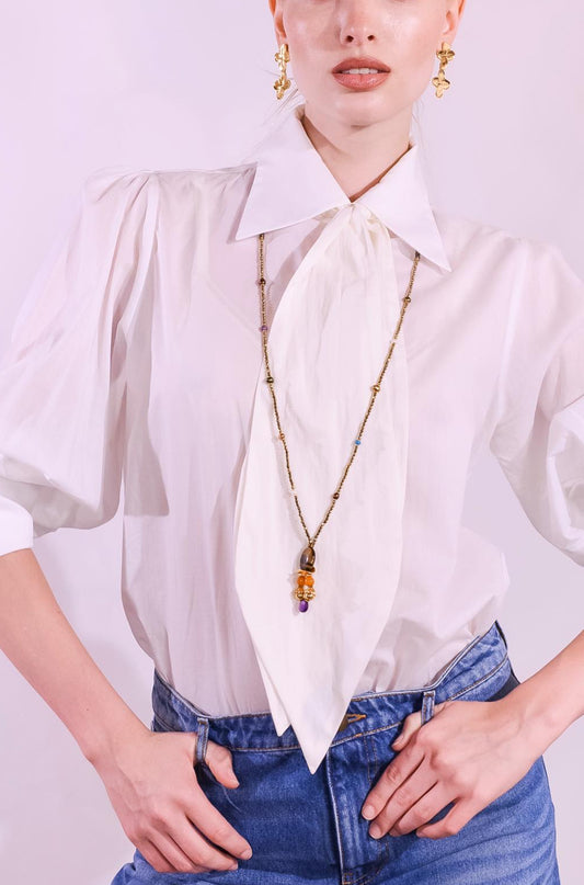 Gold and Tiger’s Eye Totem Pendant choker necklace by Ilaria Fiorentini Jewellery, featuring tiger’s eye, pyrite, turquoise, freshwater pearls, amber resin, natural amethyst, and raw brass details. Handcrafted in Italy, inspired by African and Indonesian artisan traditions. Part of House of Woven Stories selection.