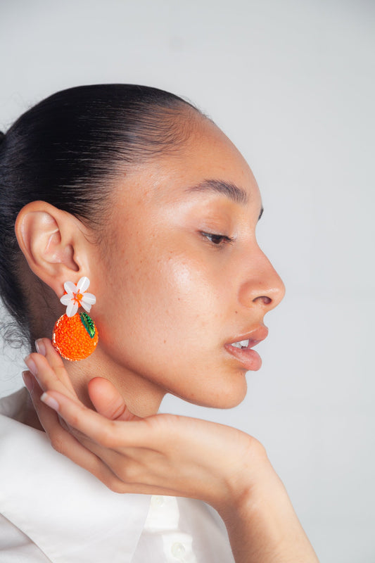 Hand-beaded orange earrings with seed beads and sequins, gold-plated brass posts, from Olivia Dar’s summer fruit collection.