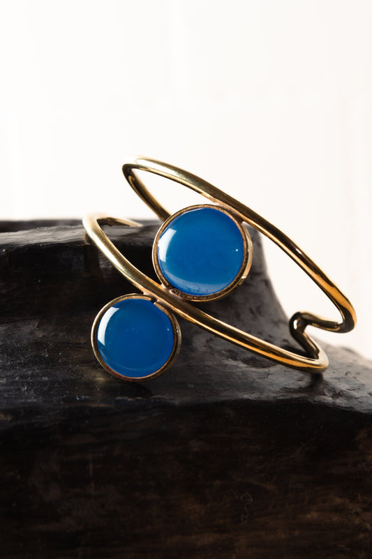 Royal Blue Double Third Eye hammered bronze bracelet by Stéphane Szendy with symmetrical enamel eye motifs. By House of Woven Stories.