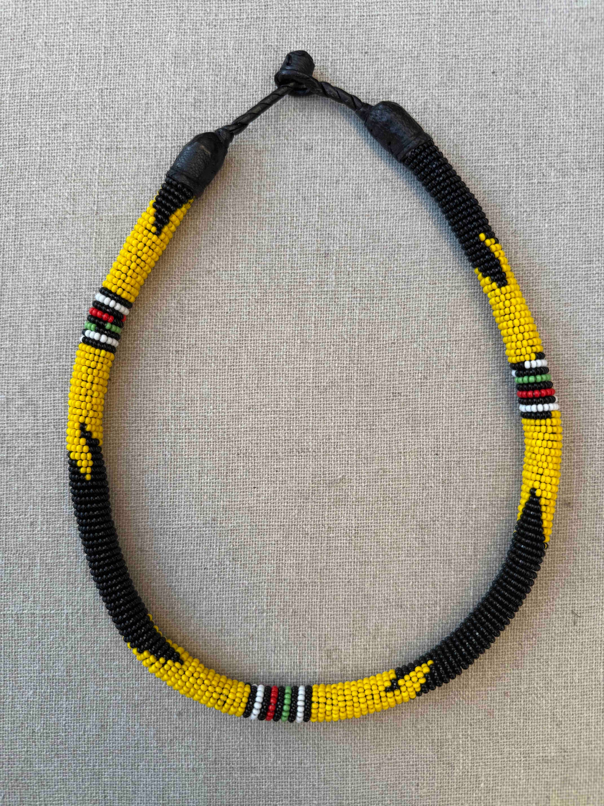Multicolor beaded necklace handcrafted by Maasai women artisans in Kenya, featuring intricate glass beadwork. Curated by House of Woven Stories.