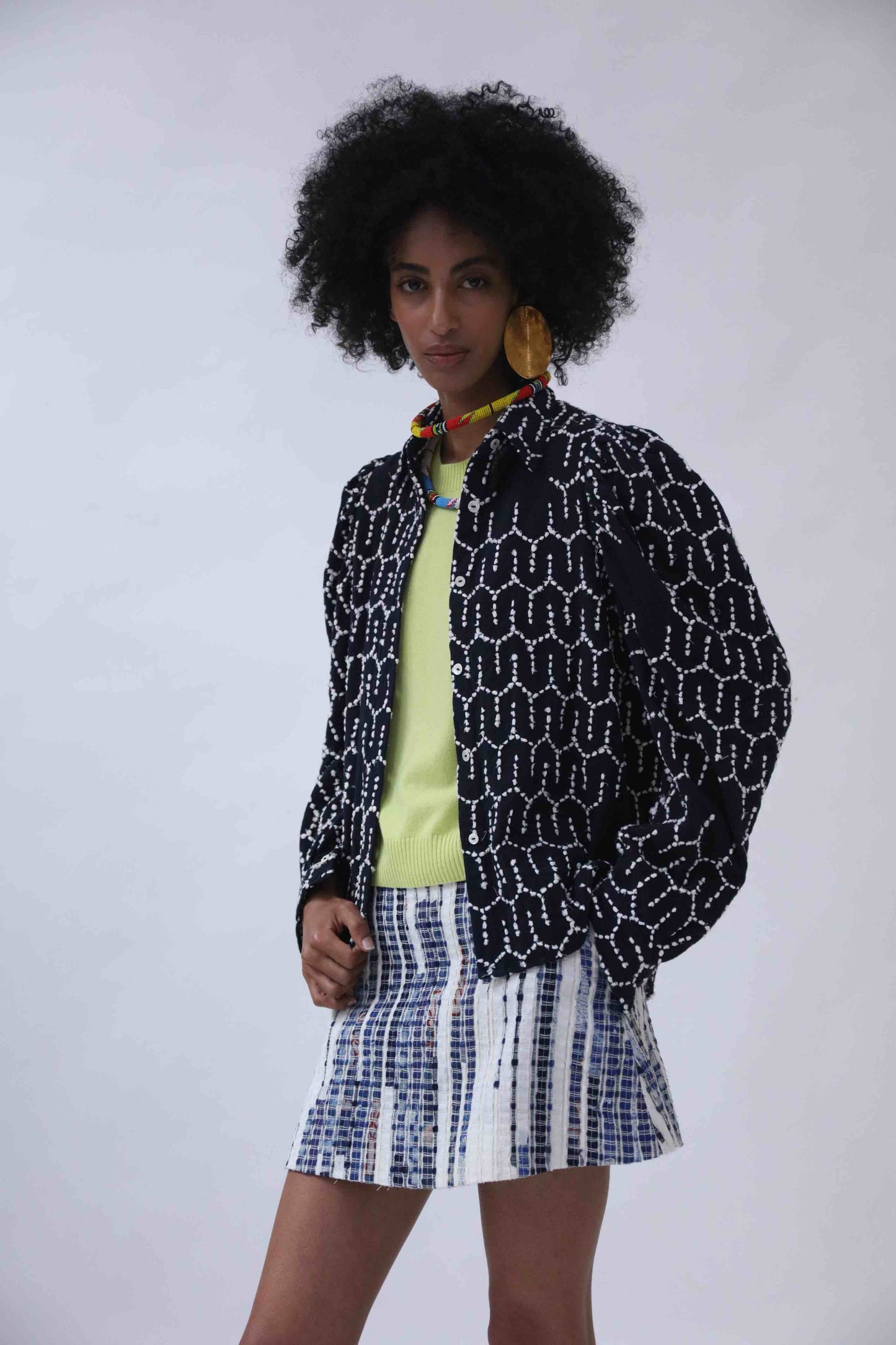 Structured puff-sleeve blouse with sharp collars and Paiwand’s signature upcycled embroidery on organic indigo-dyed cotton, handcrafted in India combining traditional craftsmanship with sustainable, modern fashion.
