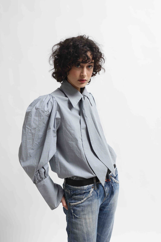 Karin Check Shirt by House of Woven Stories, handcrafted in Italy from 100% organic cotton, featuring puffed sleeves, a detachable tie, and a refined check pattern – a timeless, sustainable wardrobe piece.