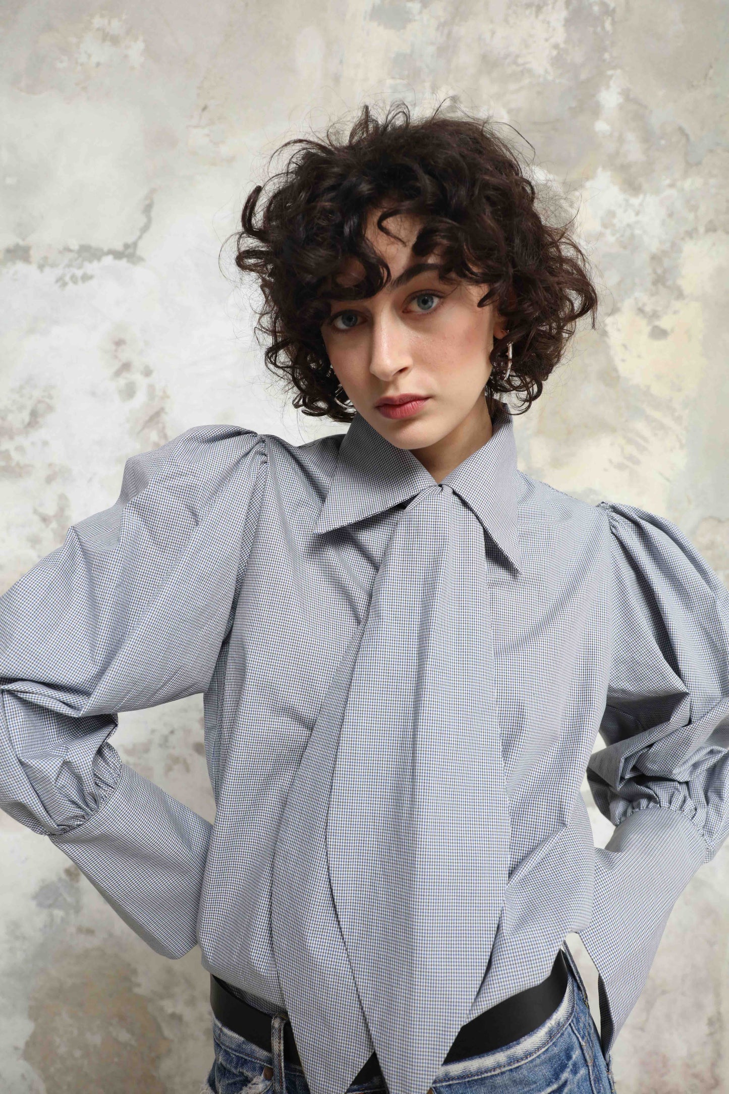 Karin Check Shirt by House of Woven Stories, handcrafted in Italy from 100% organic cotton, featuring puffed sleeves, a detachable tie, and a refined check pattern – a timeless, sustainable wardrobe piece.