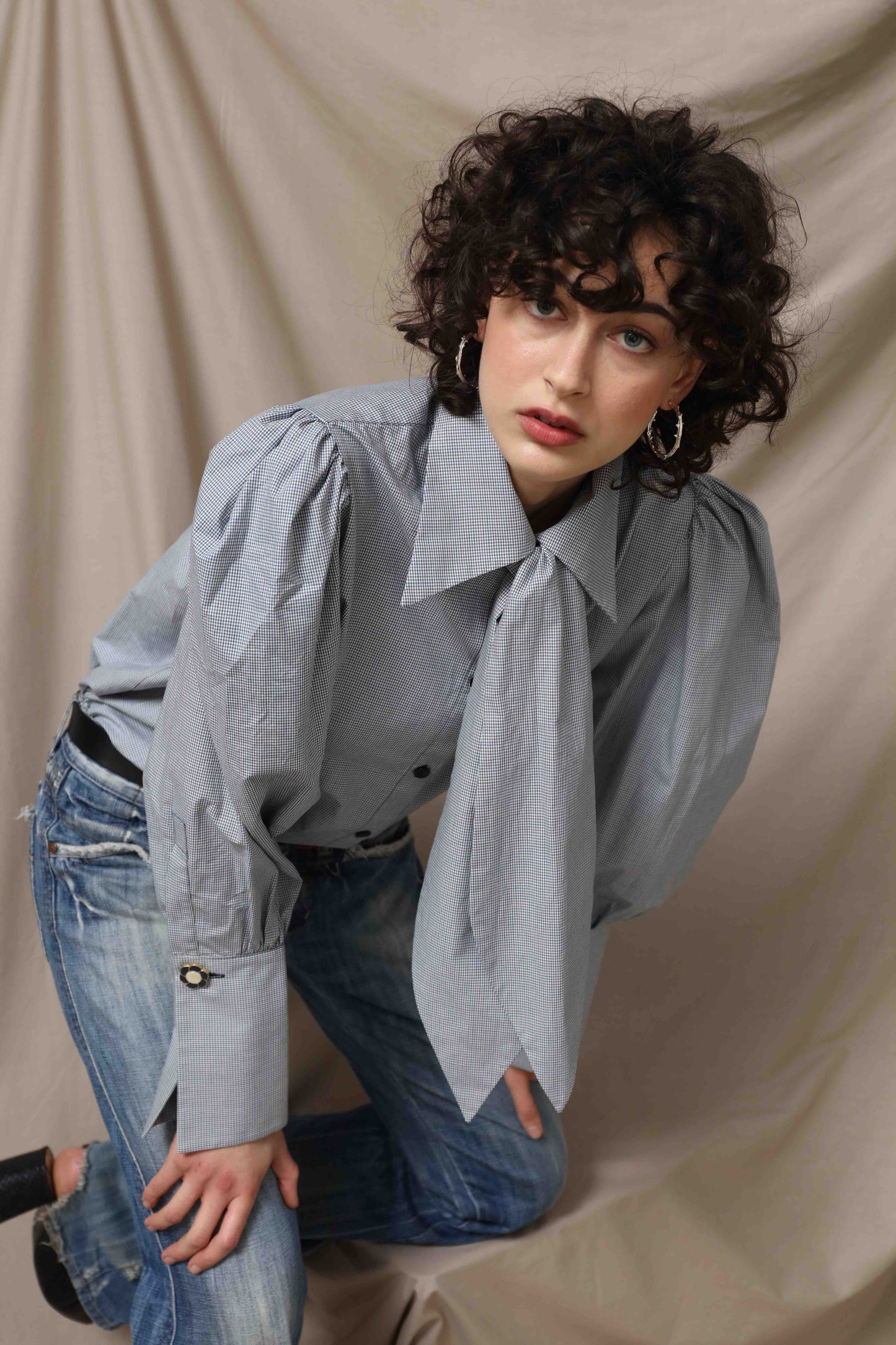 Karin Check Shirt by House of Woven Stories, handcrafted in Italy from 100% organic cotton, featuring puffed sleeves, a detachable tie, and a refined check pattern – a timeless, sustainable wardrobe piece.