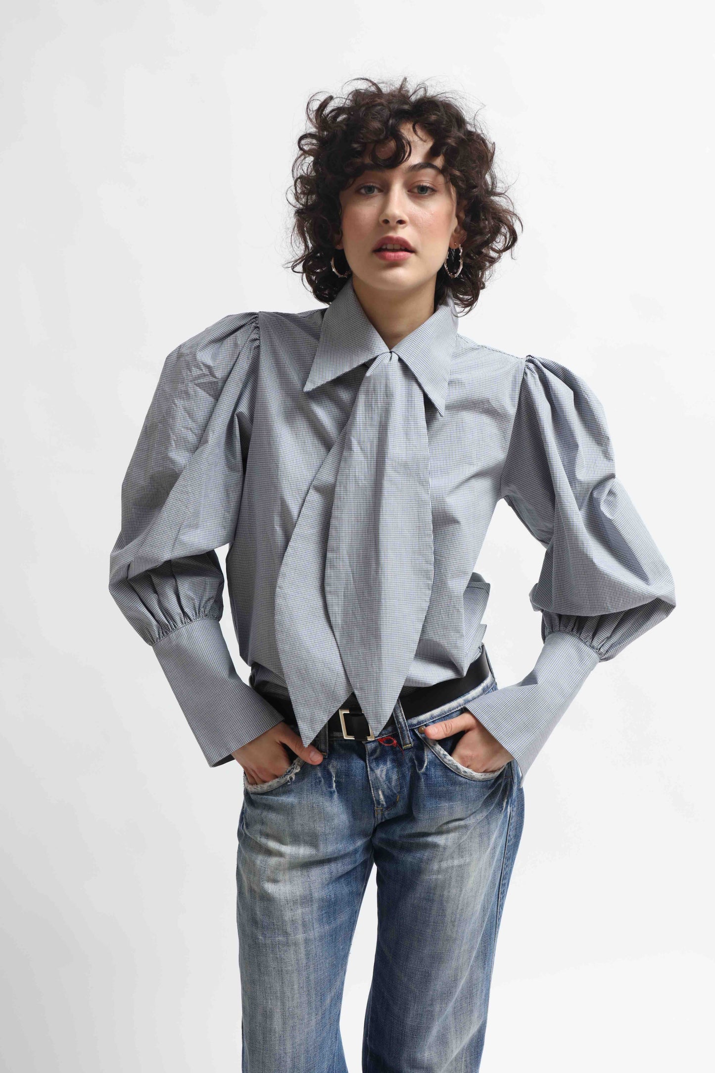 Karin Check Shirt by House of Woven Stories, handcrafted in Italy from 100% organic cotton, featuring puffed sleeves, a detachable tie, and a refined check pattern – a timeless, sustainable wardrobe piece.