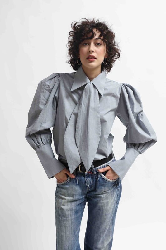 Karin Check Shirt by House of Woven Stories, handcrafted in Italy from 100% organic cotton, featuring puffed sleeves, a detachable tie, and a refined check pattern – a timeless, sustainable wardrobe piece.