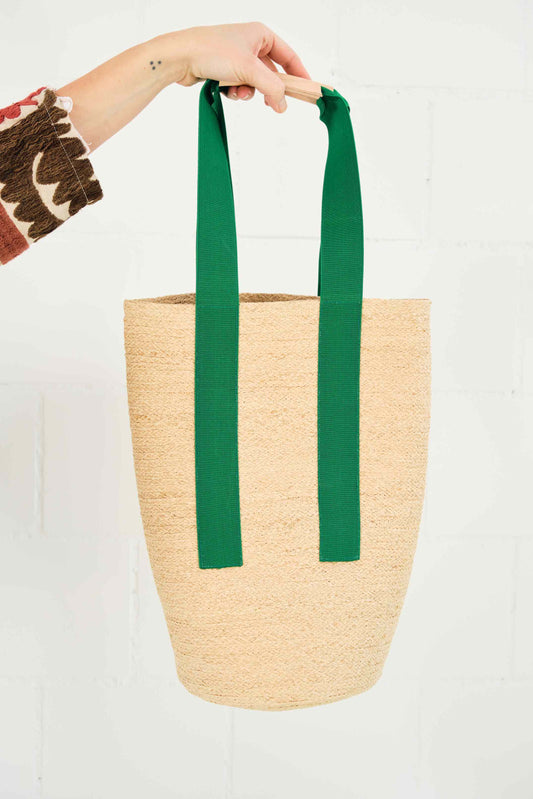 Green raffia Cornichon tote bag with emerald elastic straps and natural leather handle by Lola Hats. Part of House of Woven Stories selection.