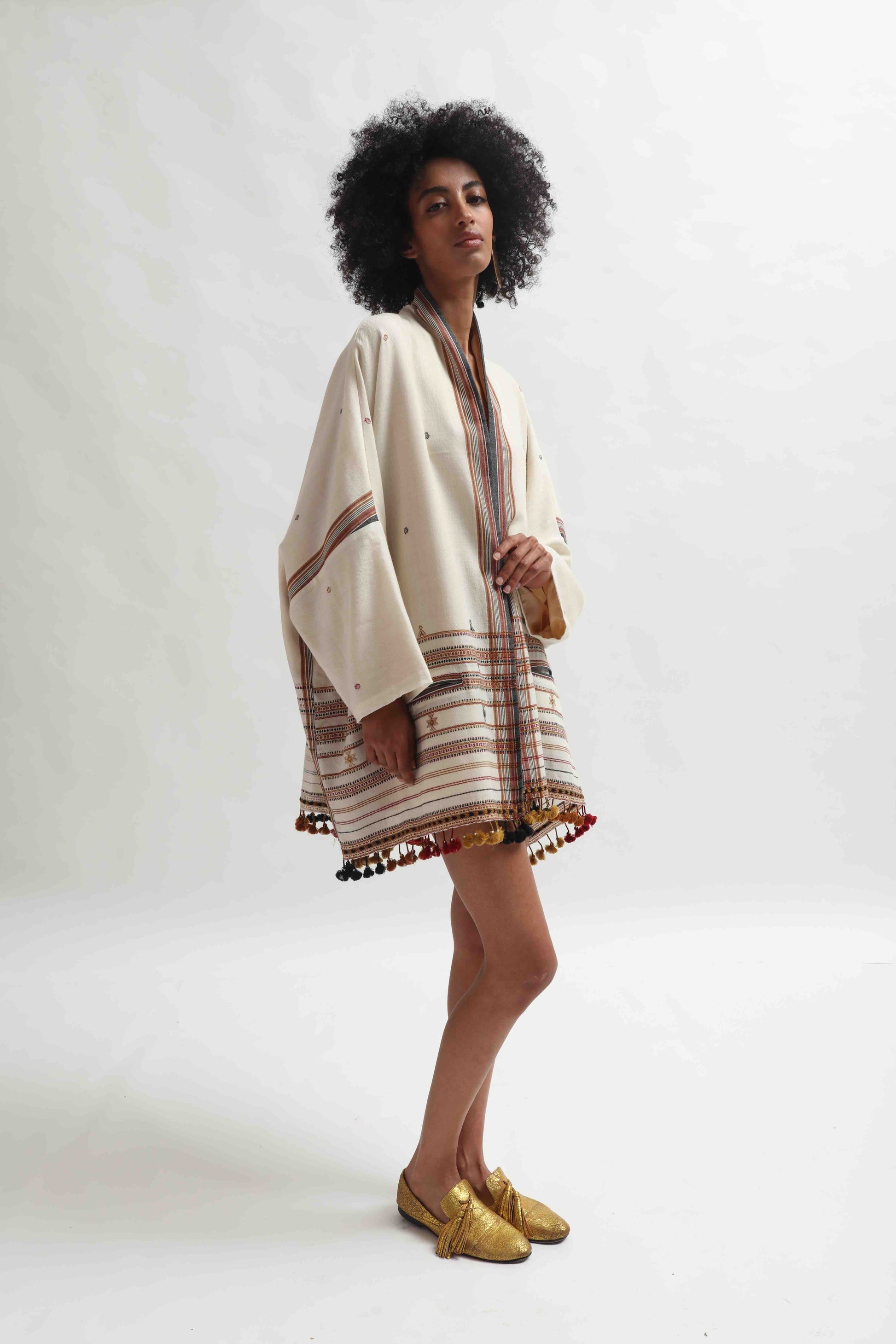 Model wearing the Kyoto Kimono Jacket in off-white handwoven merino wool with natural indigo patterns, lined in pure silk. Oversized fit, artisanal details, and bohemian elegance by House of Woven Stories.