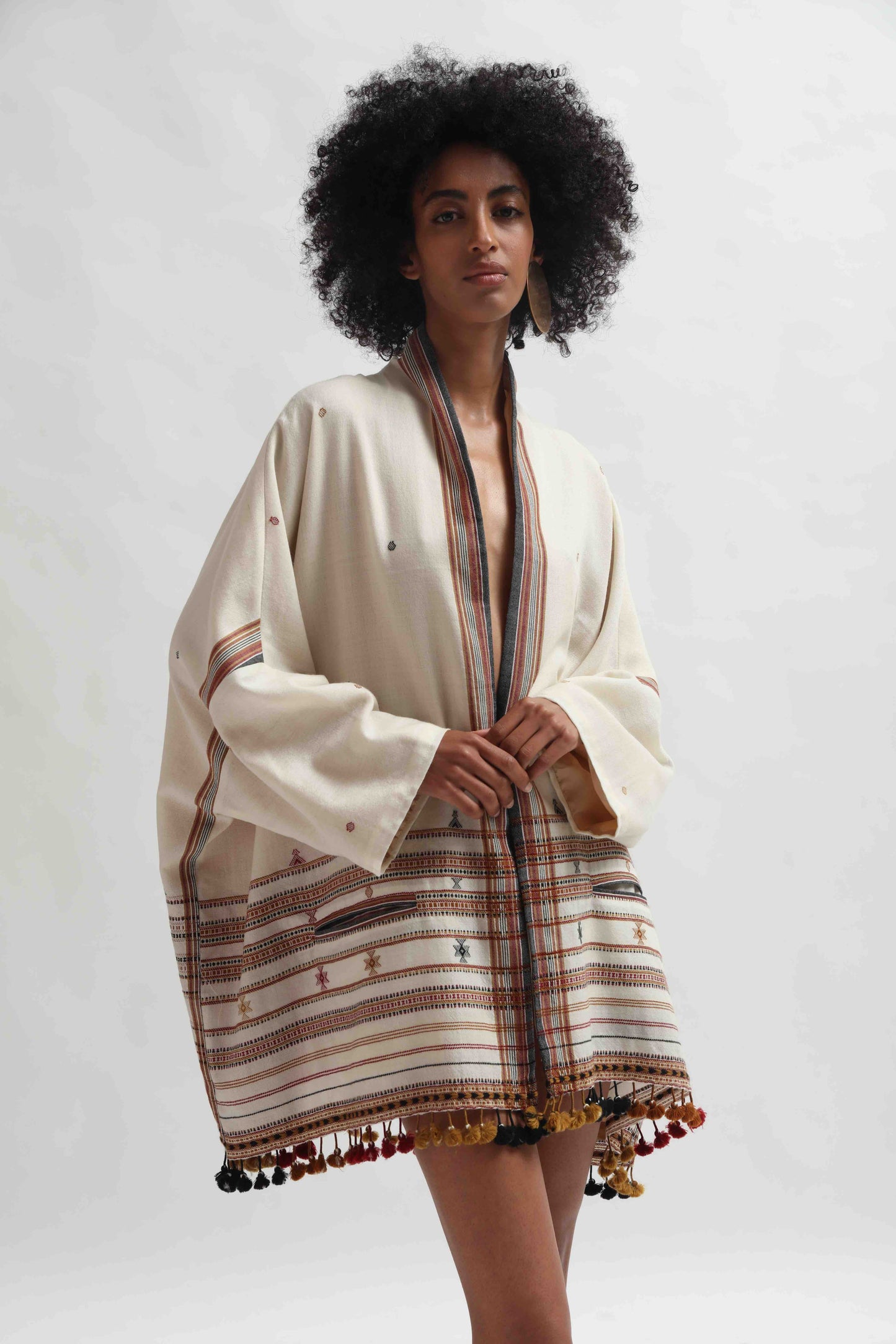 Model wearing the Kyoto Kimono Jacket in off-white handwoven merino wool with natural indigo patterns, lined in pure silk. Oversized fit, artisanal details, and bohemian elegance by House of Woven Stories.