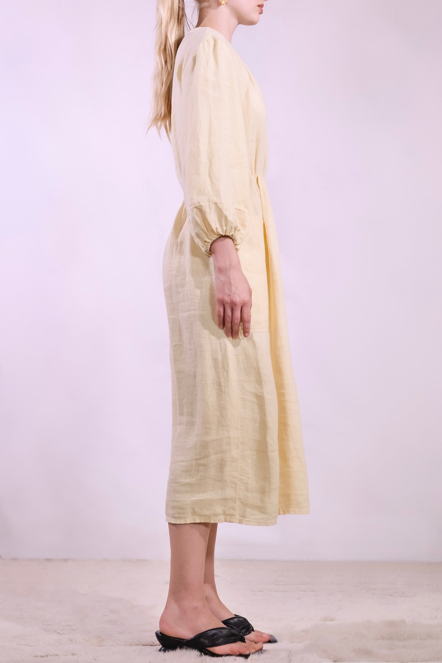 Model is wearing La Robe Bohème in banana yellow linen by Happy Haus - a timeless, feminine midi dress crafted from sustainable fabric with an effortless Parisian feel. Part of House of Woven Stories selection.