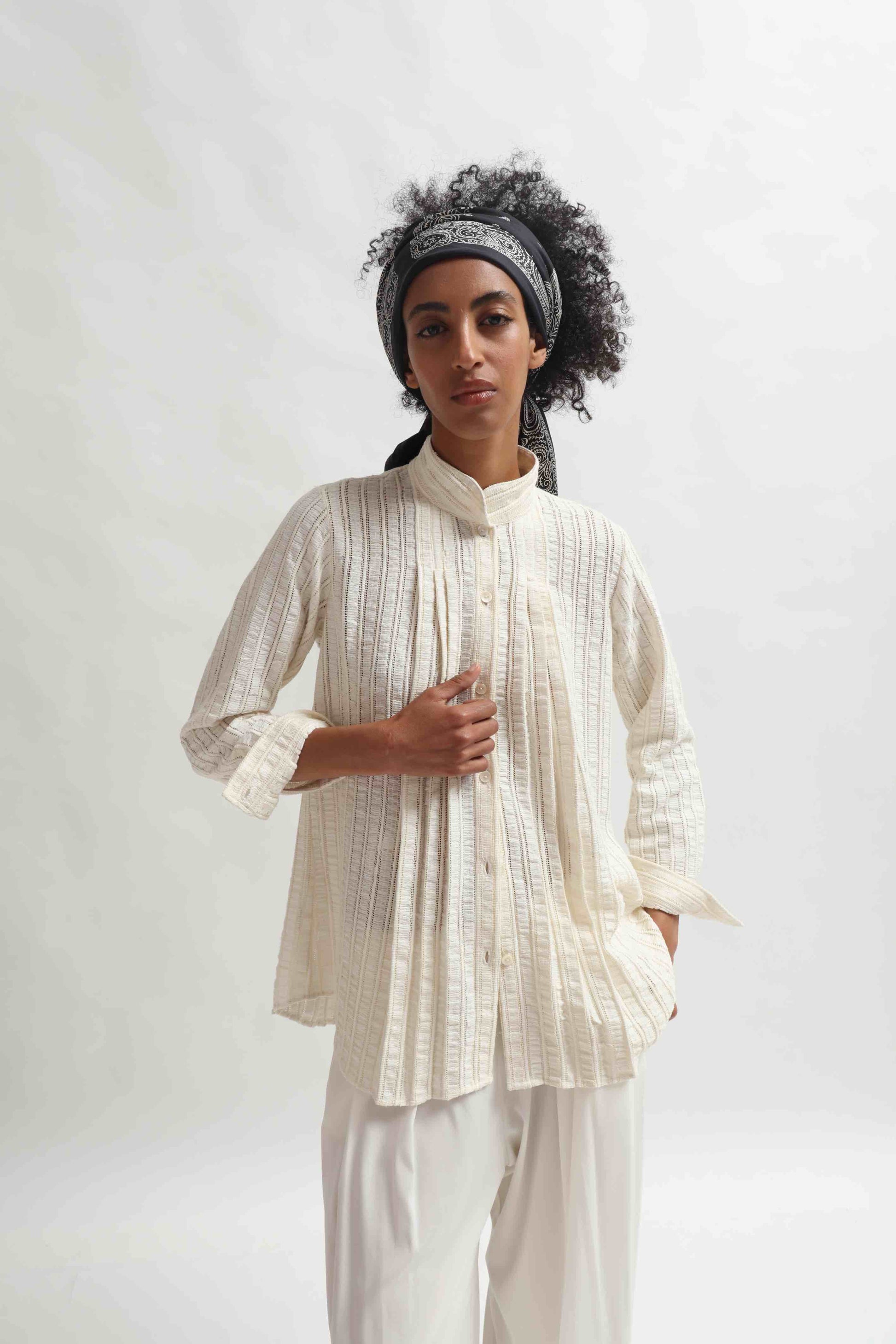 Leno Pleated Shirt by Paiwand made from upcycled cotton with breathable leno weave, featuring elegant pleats and handcrafted in India. Sustainable fashion curated by House of Woven Stories.
