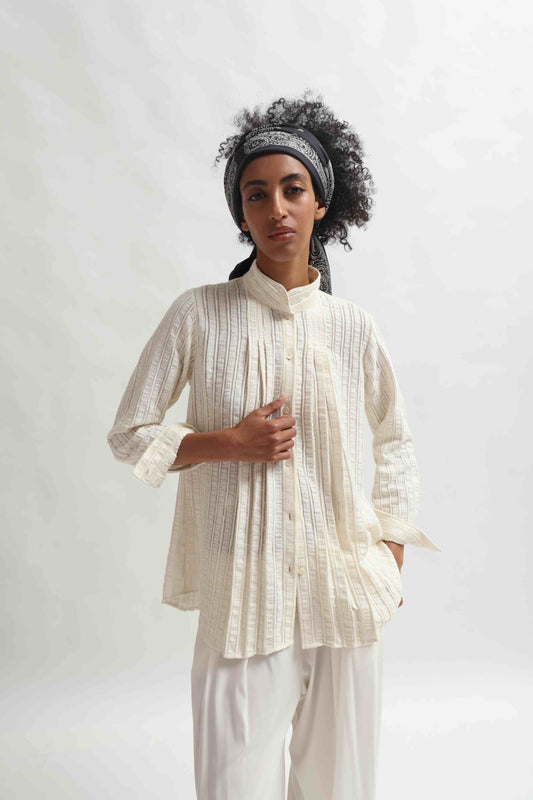 Leno Pleated Shirt by Paiwand made from upcycled cotton with breathable leno weave, featuring elegant pleats and handcrafted in India. Sustainable fashion curated by House of Woven Stories.