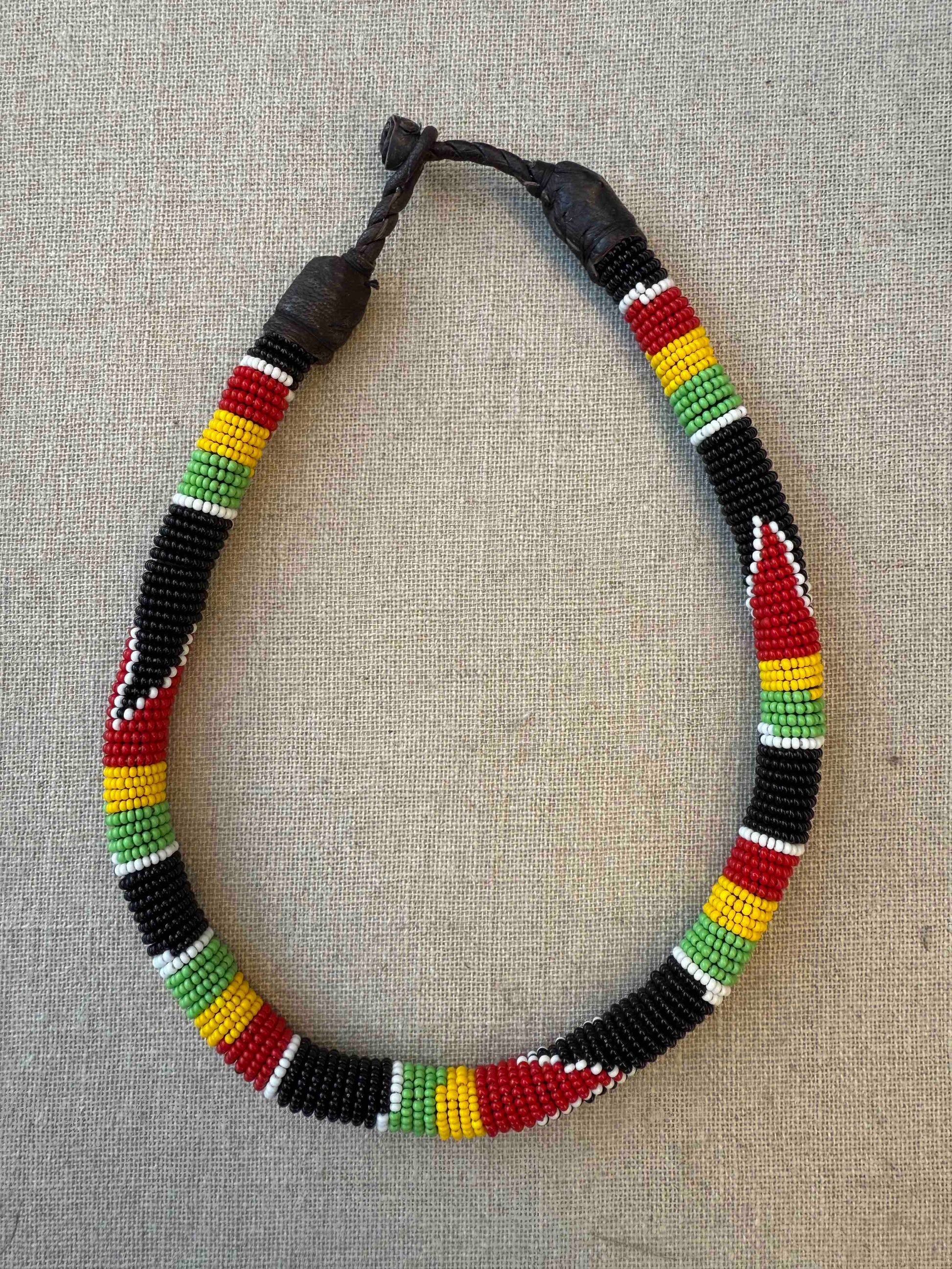 Multicolor beaded necklace handcrafted by Maasai women artisans in Kenya, featuring intricate glass beadwork. Curated by House of Woven Stories.