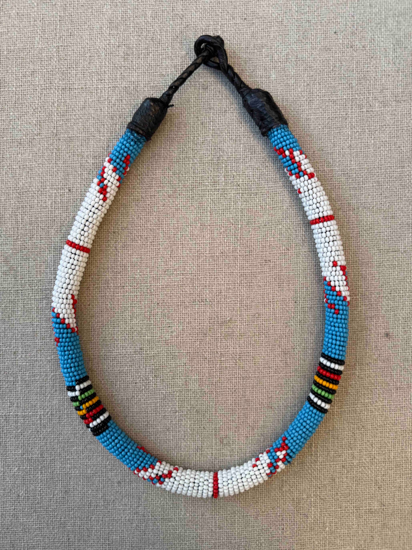 Multicolor beaded necklace handcrafted by Maasai women artisans in Kenya, featuring intricate glass beadwork. Curated by House of Woven Stories.