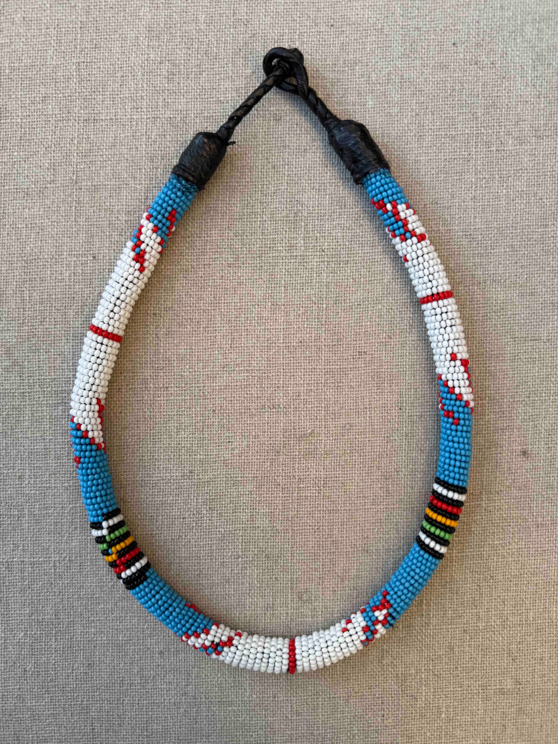 Multicolor beaded necklace handcrafted by Maasai women artisans in Kenya, featuring intricate glass beadwork. Curated by House of Woven Stories.