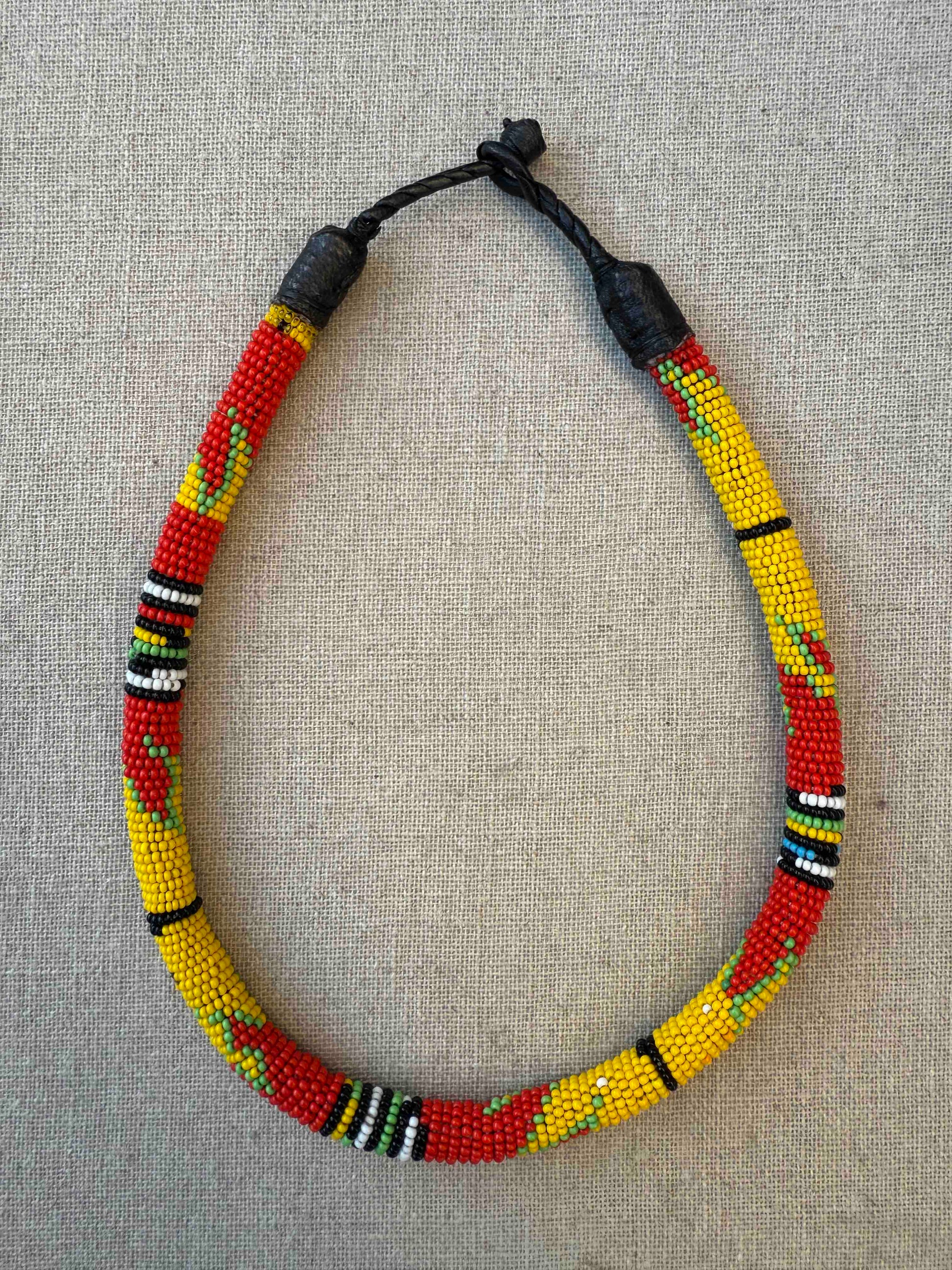 Multicolor beaded necklace handcrafted by Maasai women artisans in Kenya, featuring intricate glass beadwork. Curated by House of Woven Stories.