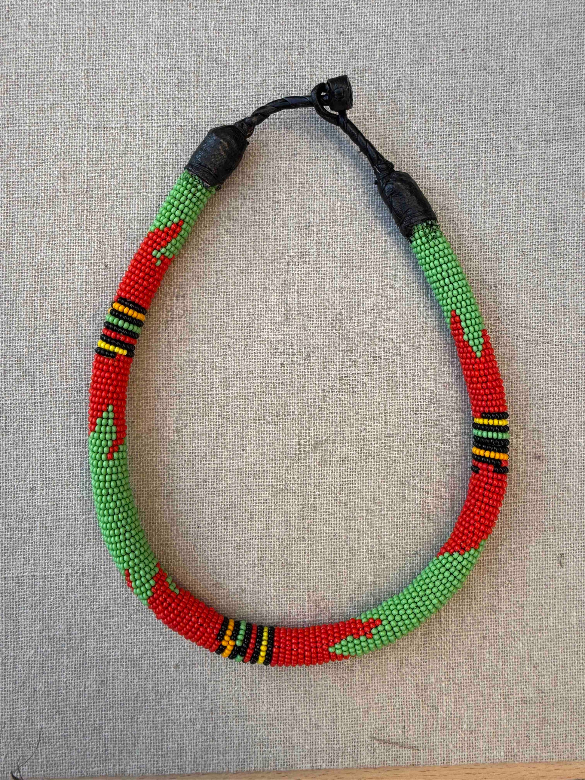 Multicolor beaded necklace handcrafted by Maasai women artisans in Kenya, featuring intricate glass beadwork. Curated by House of Woven Stories.
