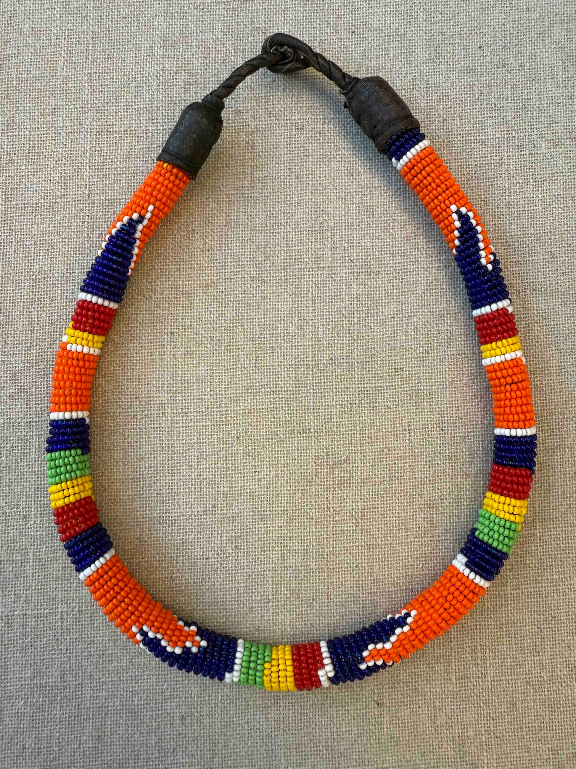 Multicolor beaded necklace handcrafted by Maasai women artisans in Kenya, featuring intricate glass beadwork. Curated by House of Woven Stories.