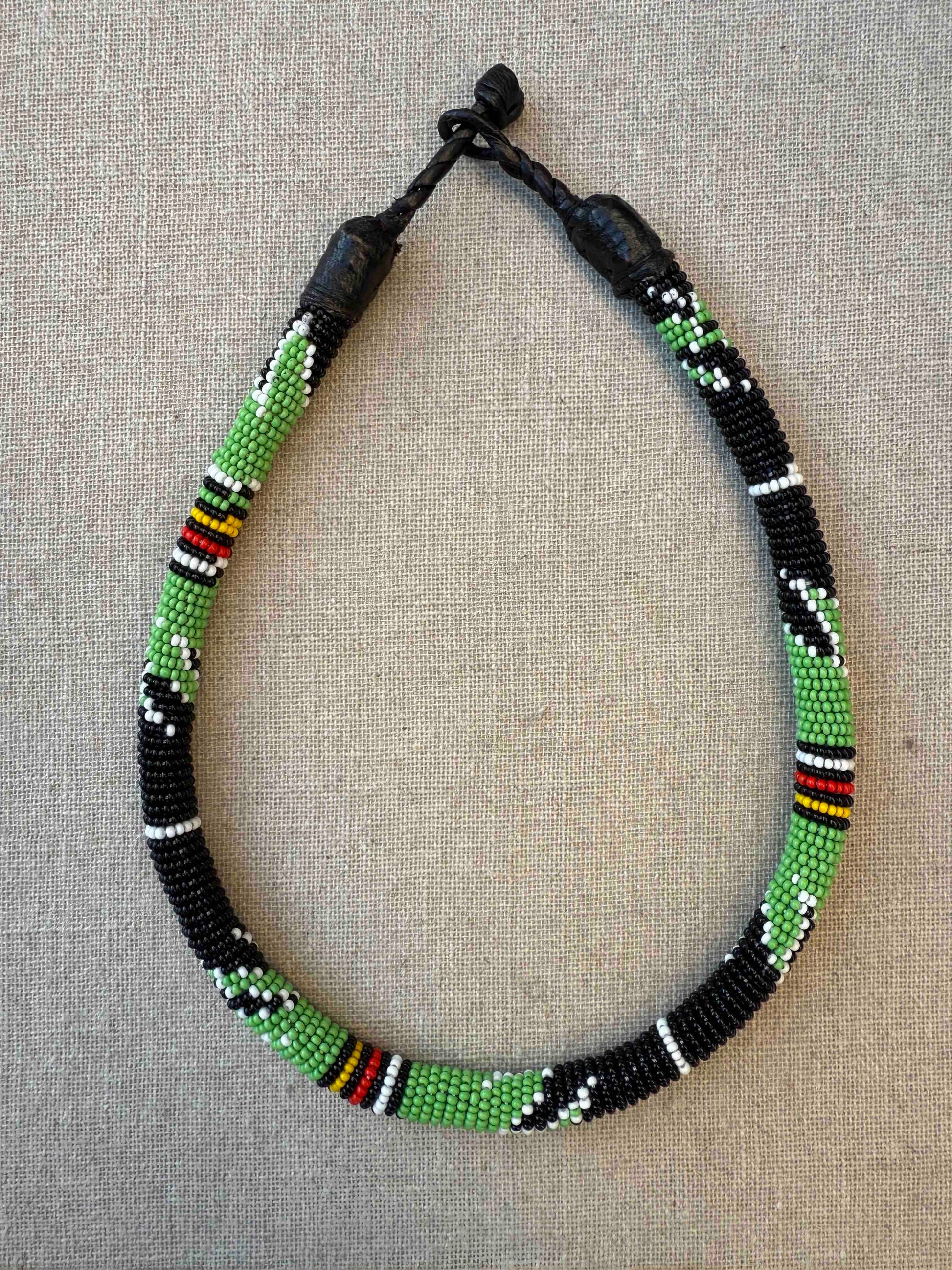 Multicolor beaded necklace handcrafted by Maasai women artisans in Kenya, featuring intricate glass beadwork. Curated by House of Woven Stories.