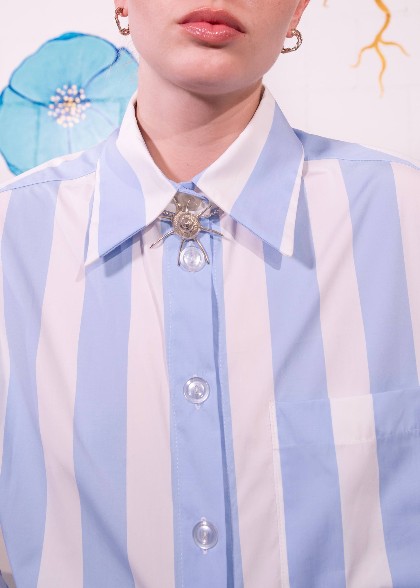 Sky-blue and white macro striped Oscar Blouse in organic cotton with classic collar and relaxed fit, handmade in Italy by House of Woven Stories.