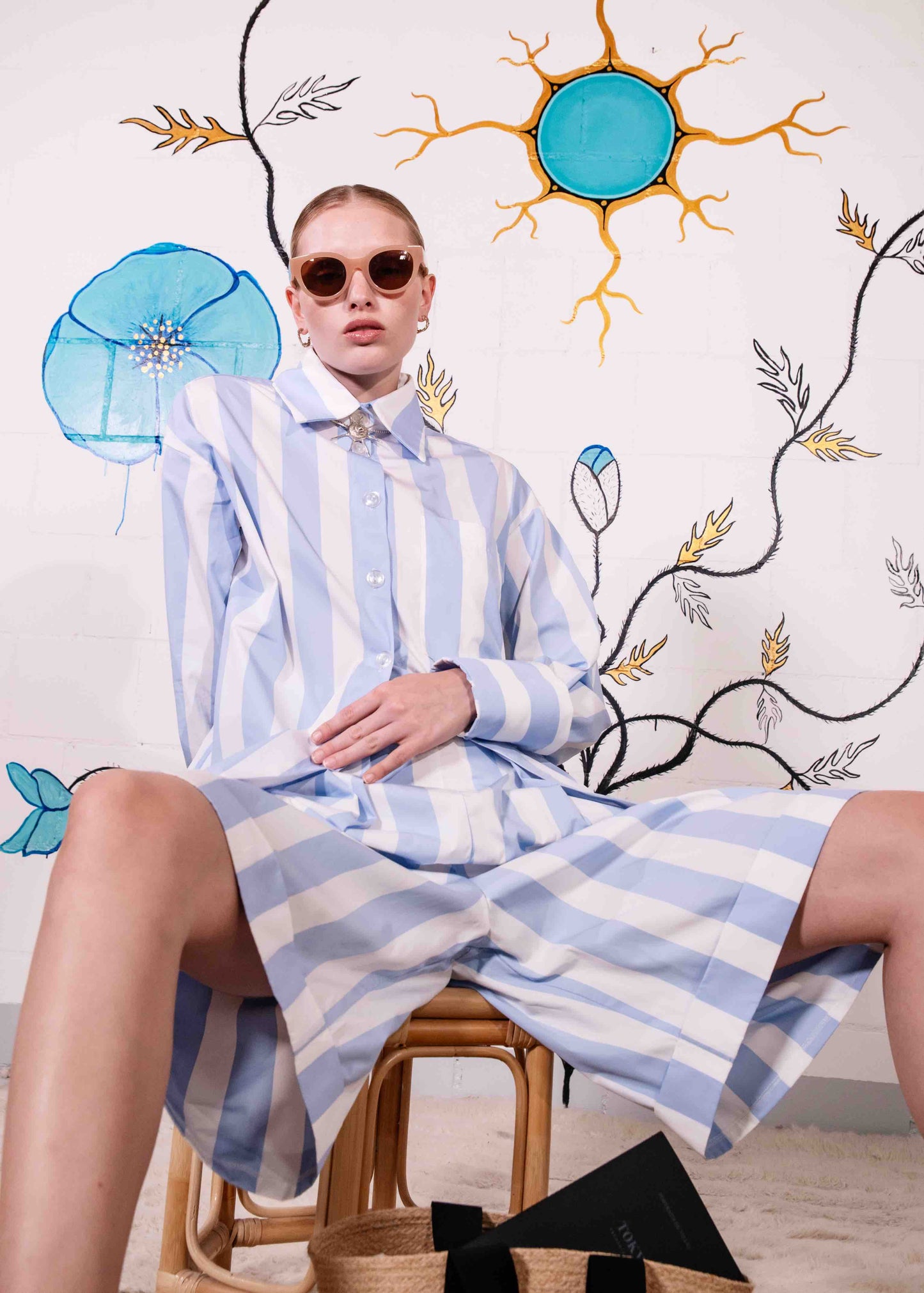 Sky-blue and white striped organic cotton bermuda shorts with pleats and side pockets, handmade in Italy by House of Woven Stories.