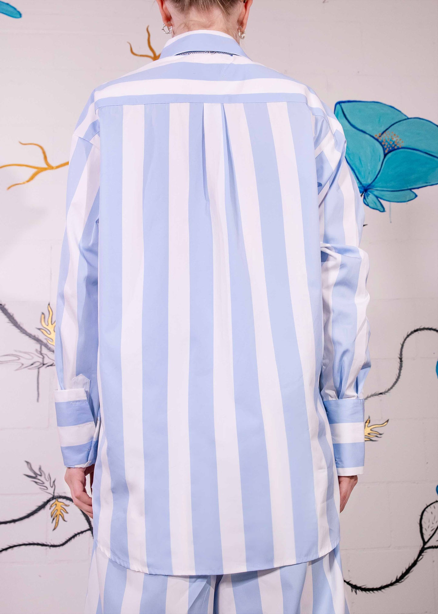Sky-blue and white macro striped Oscar Blouse in organic cotton with classic collar and relaxed fit, handmade in Italy by House of Woven Stories.