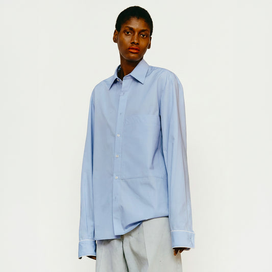 Maison Jejia Mami Shirt in light blue with elongated sleeves, wide cuffs and a contemporary asymmetric hem, curated by House of Nomad Stories