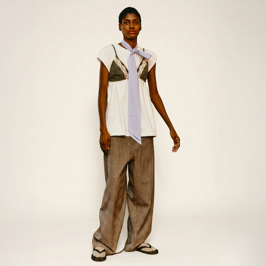 Model is wearing the Carla Cotton Pant by Maison Jejia from House of Nomad Stories, white organic cotton wide-leg trousers with a relaxed silhouette and four pockets.