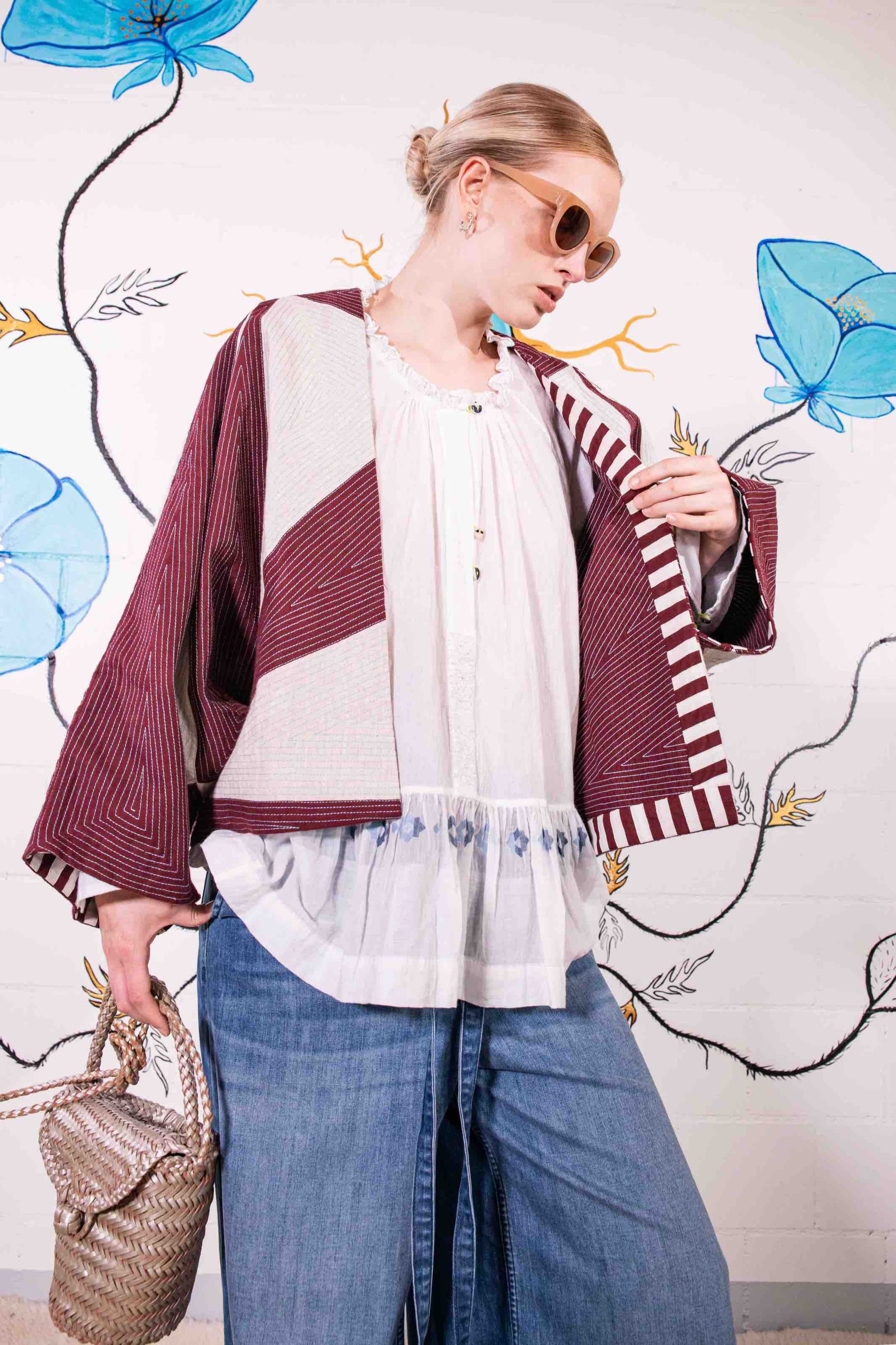 Cropped jacket in heavyweight organic cotton with hand-applied appliqué and embroidery by Ka-Sha. Features fabric button closure and easy-fit silhouette. Ethically handcrafted in India.