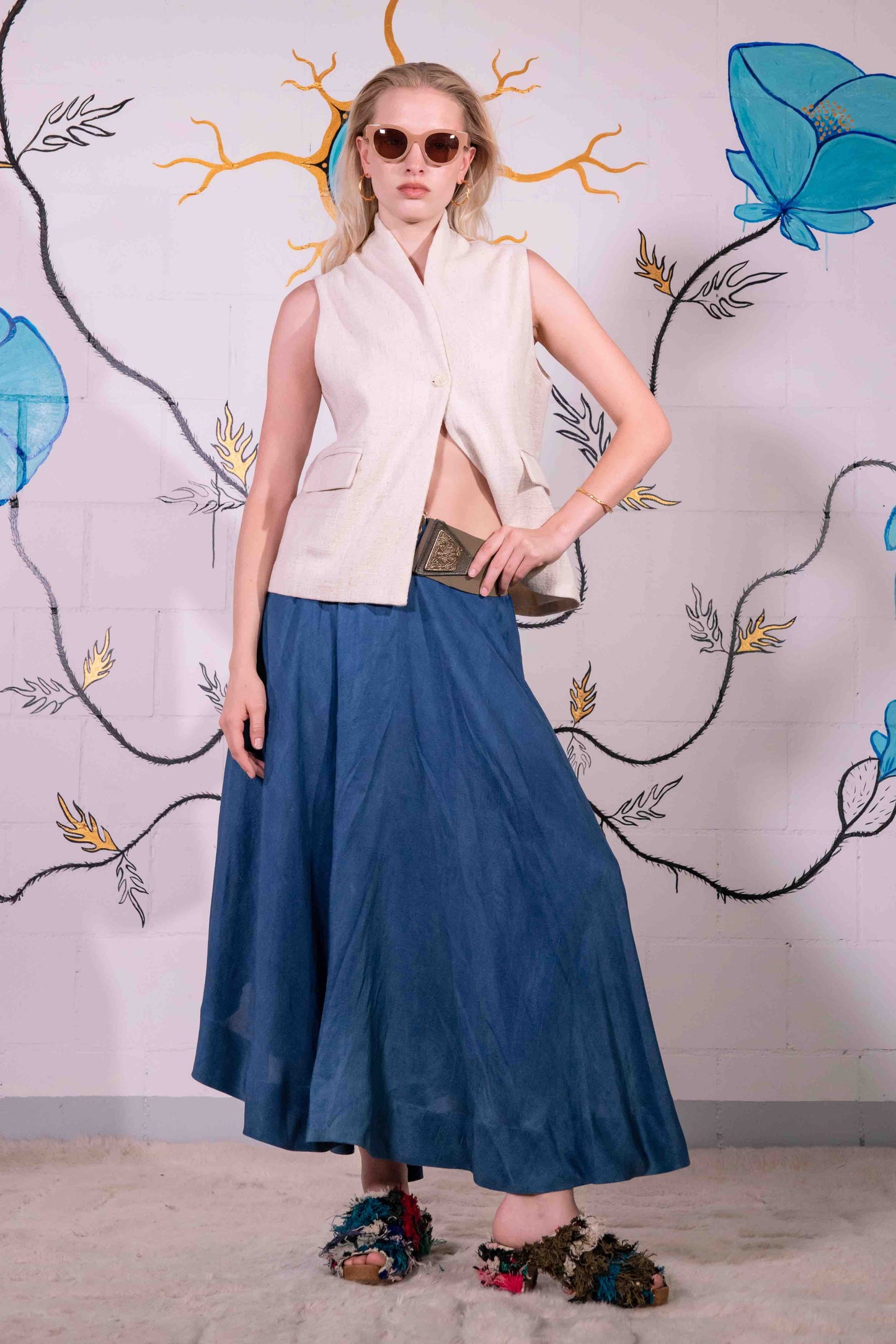 Model is wearing a natural Kala cotton waistcoat by IOWEYOU with a single-button closure and clean, minimalist design. Part of House of Woven Stories selection.