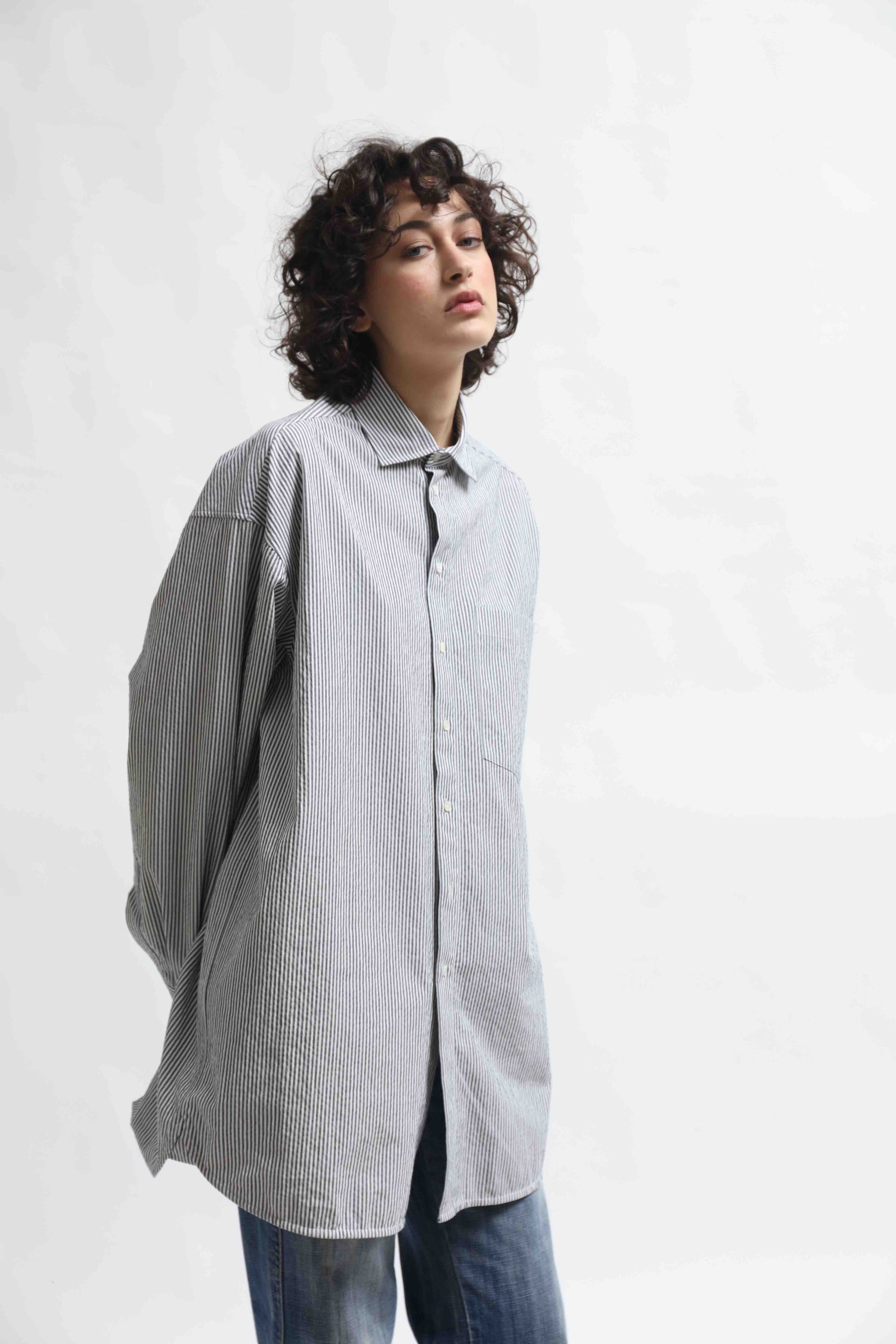 Crisp 100% organic cotton shirt with classic collar and marine blue and white stripes, handcrafted by House of Woven Stories in Italy’s Piedmont region, featuring a soft paper-touch finish and relaxed fit for versatile, refined style.