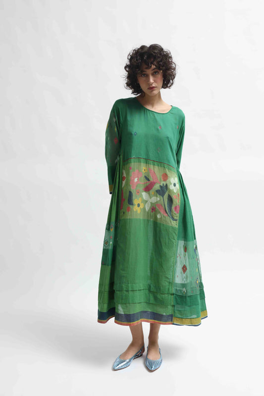 Model wearing the Rasa 01 midi dress by Injiri, handcrafted in India from pure cotton with delicate handprinted floral details on the lower half. Lightweight, artisanal, and timeless.