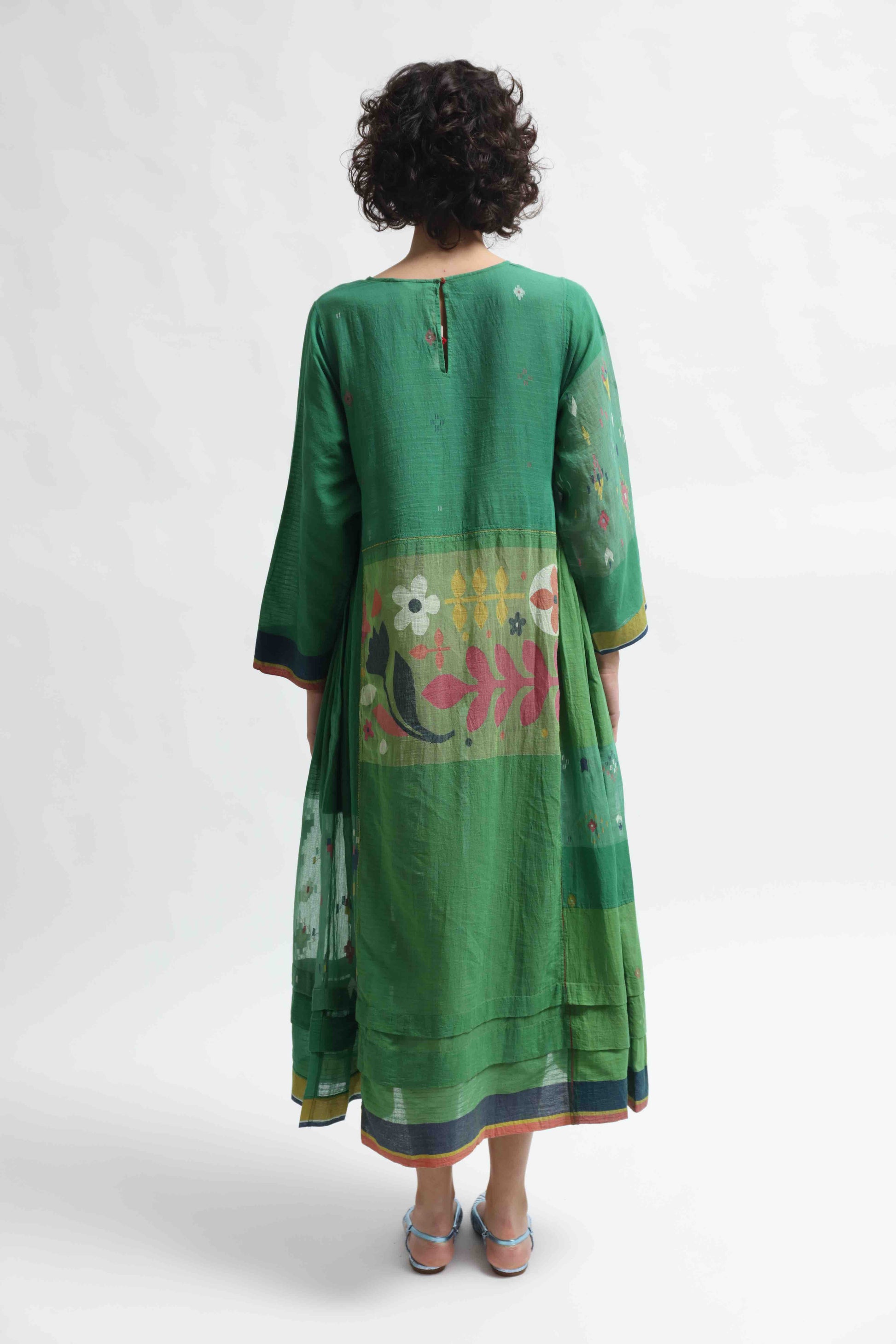 Model wearing the Rasa 01 midi dress by Injiri, handcrafted in India from pure cotton with delicate handprinted floral details on the lower half. Lightweight, artisanal, and timeless.