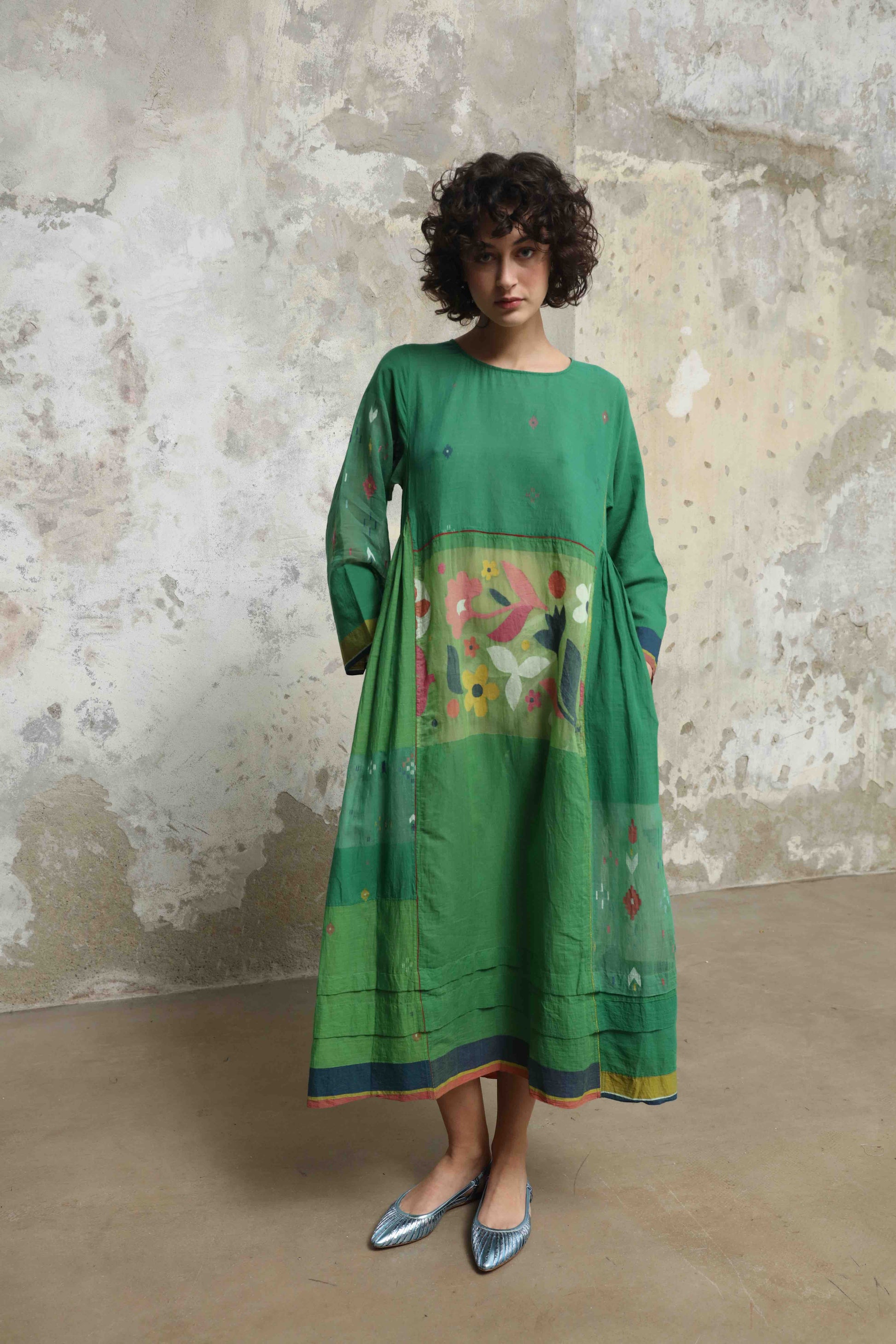 Model wearing the Rasa 01 midi dress by Injiri, handcrafted in India from pure cotton with delicate handprinted floral details on the lower half. Lightweight, artisanal, and timeless.
